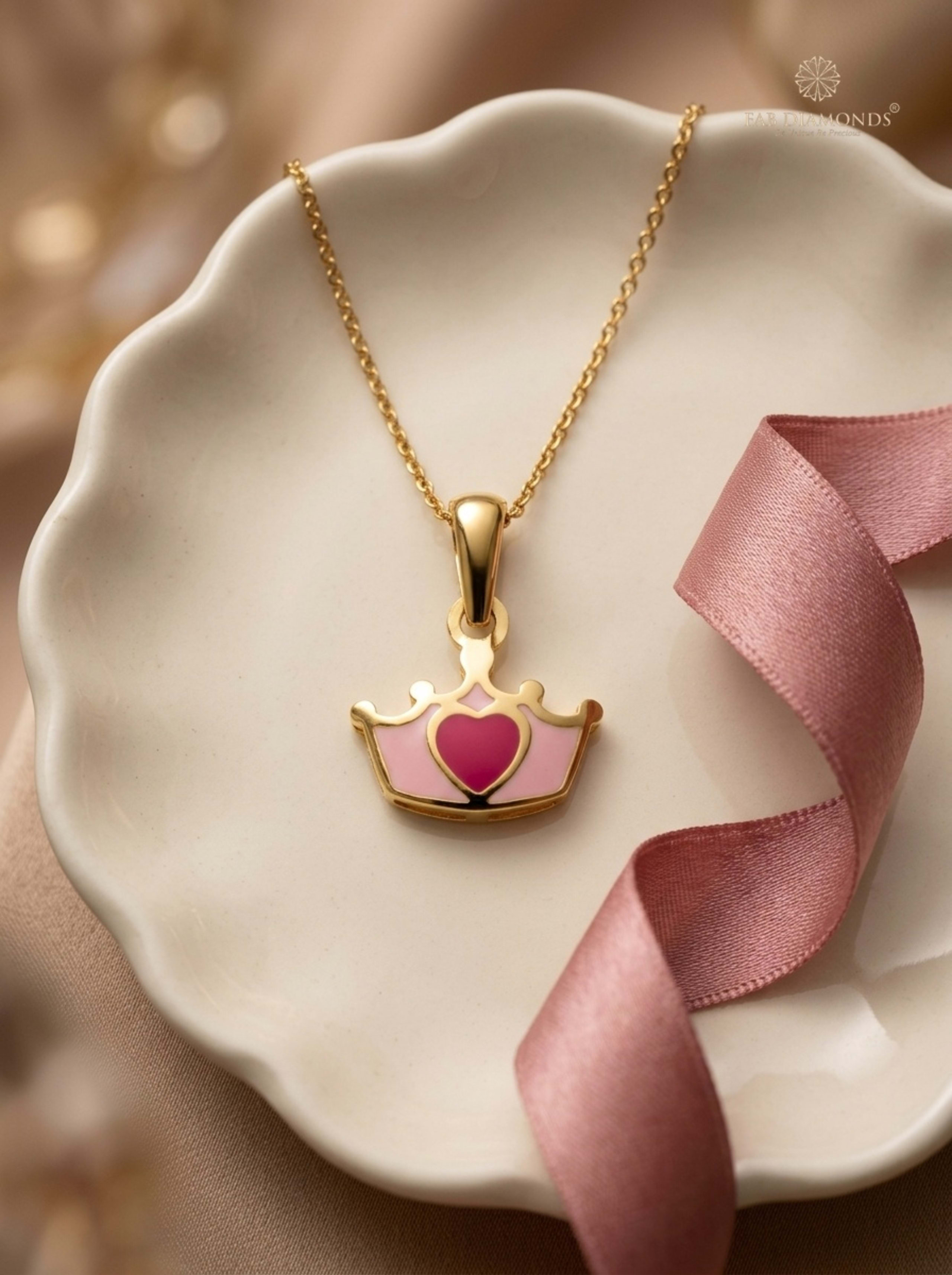 Aadya Princess Tiara Crown Enamel Baby Pendant Chain on porcelain dish