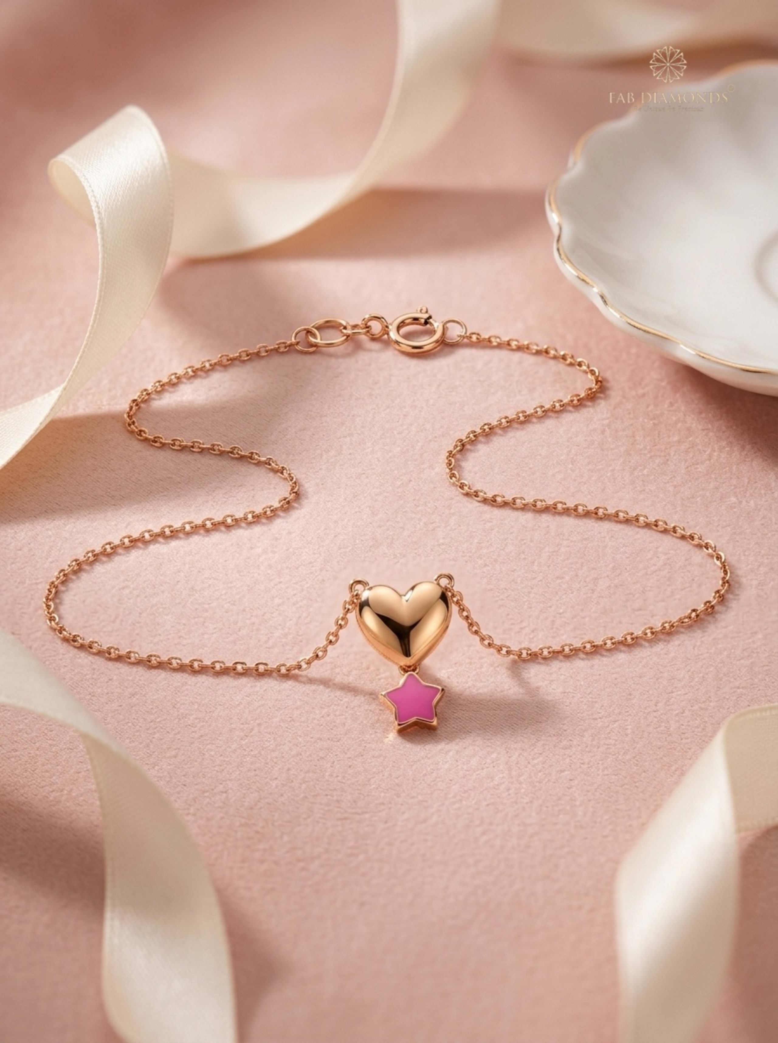 Rhea Sculpted Heart & Dangling Star Baby Gold Chain on blush velvet ground