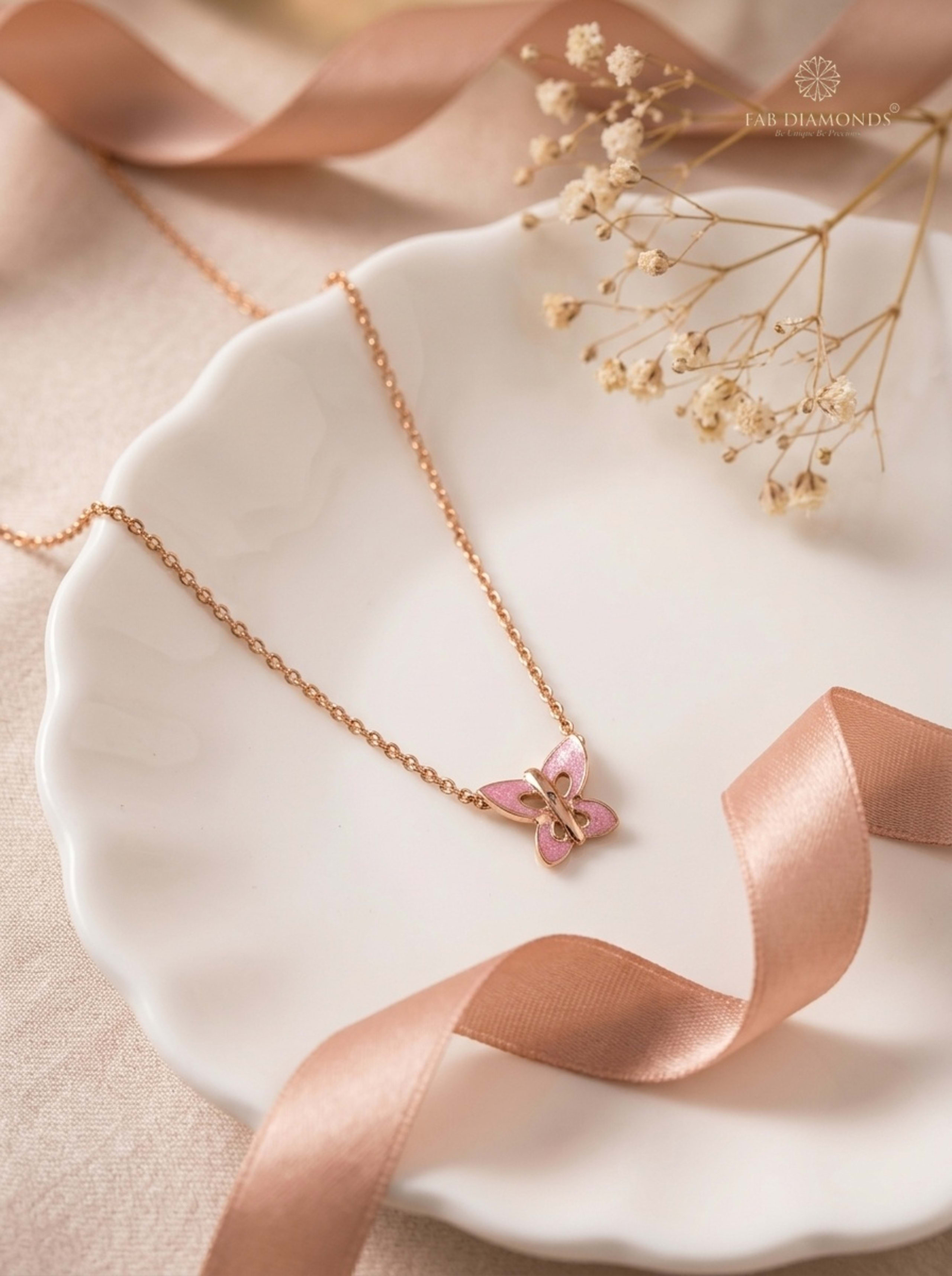 Titli Shimmer Butterfly Station Rose Gold Baby Chain on scalloped porcelain dish