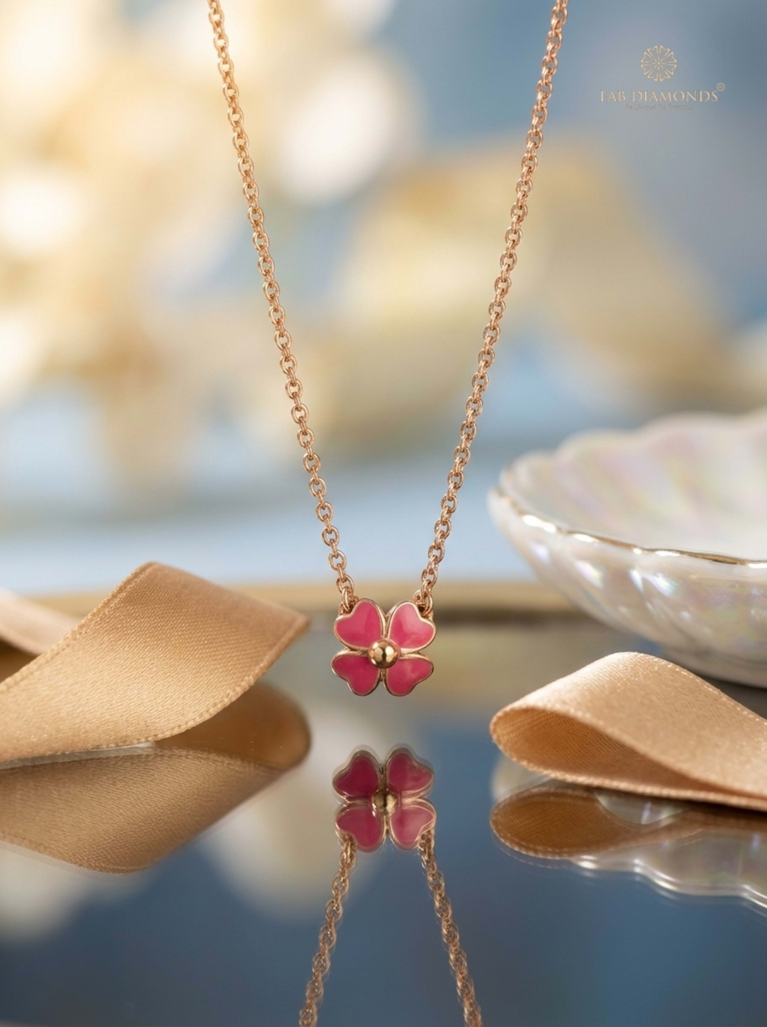 Four-Petal Blossom Clover Mirror Rose Gold Necklace reflecting on lacquer tray