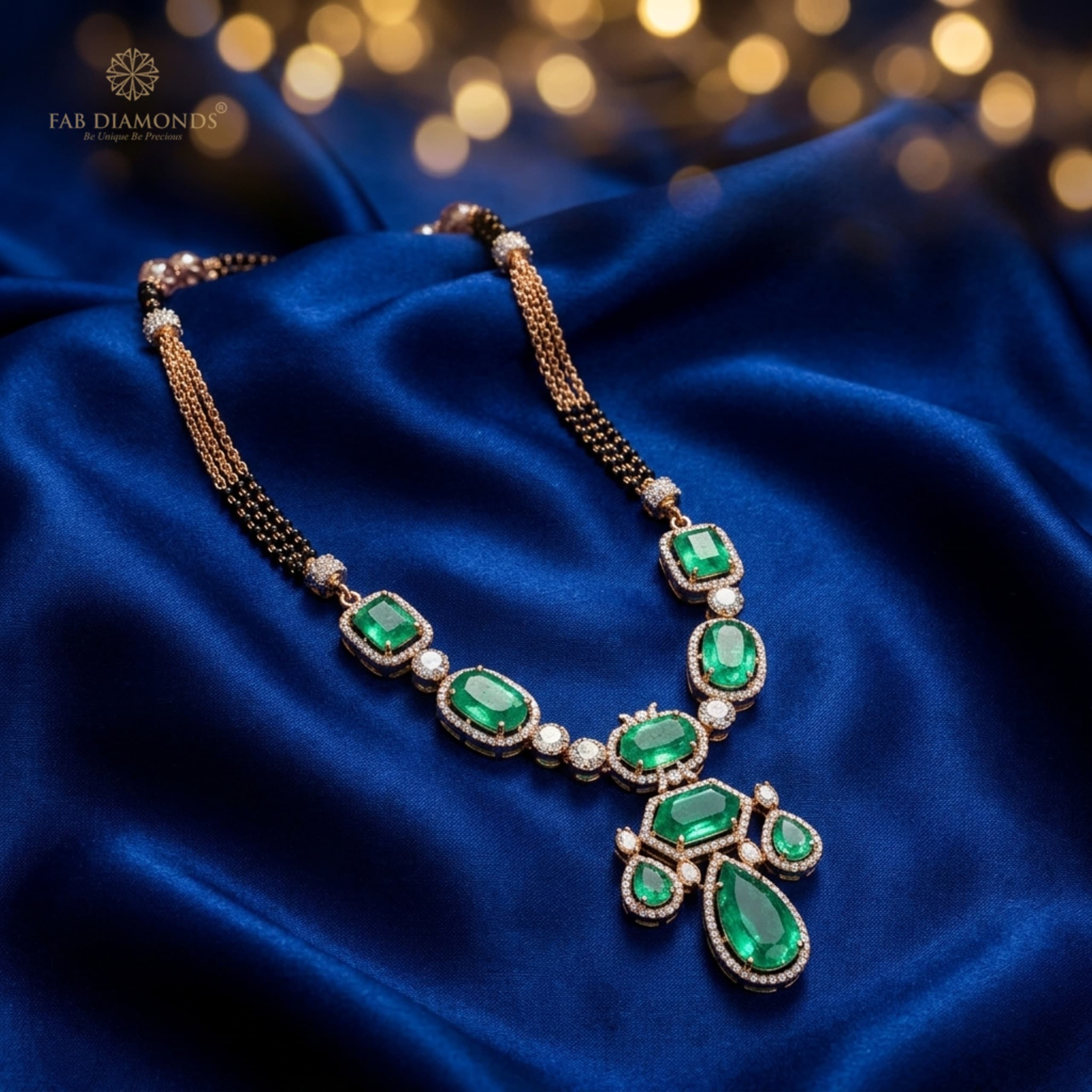 Vaidehi royal Colombian emerald and diamond collar mangalsutra on draped royal blue silk