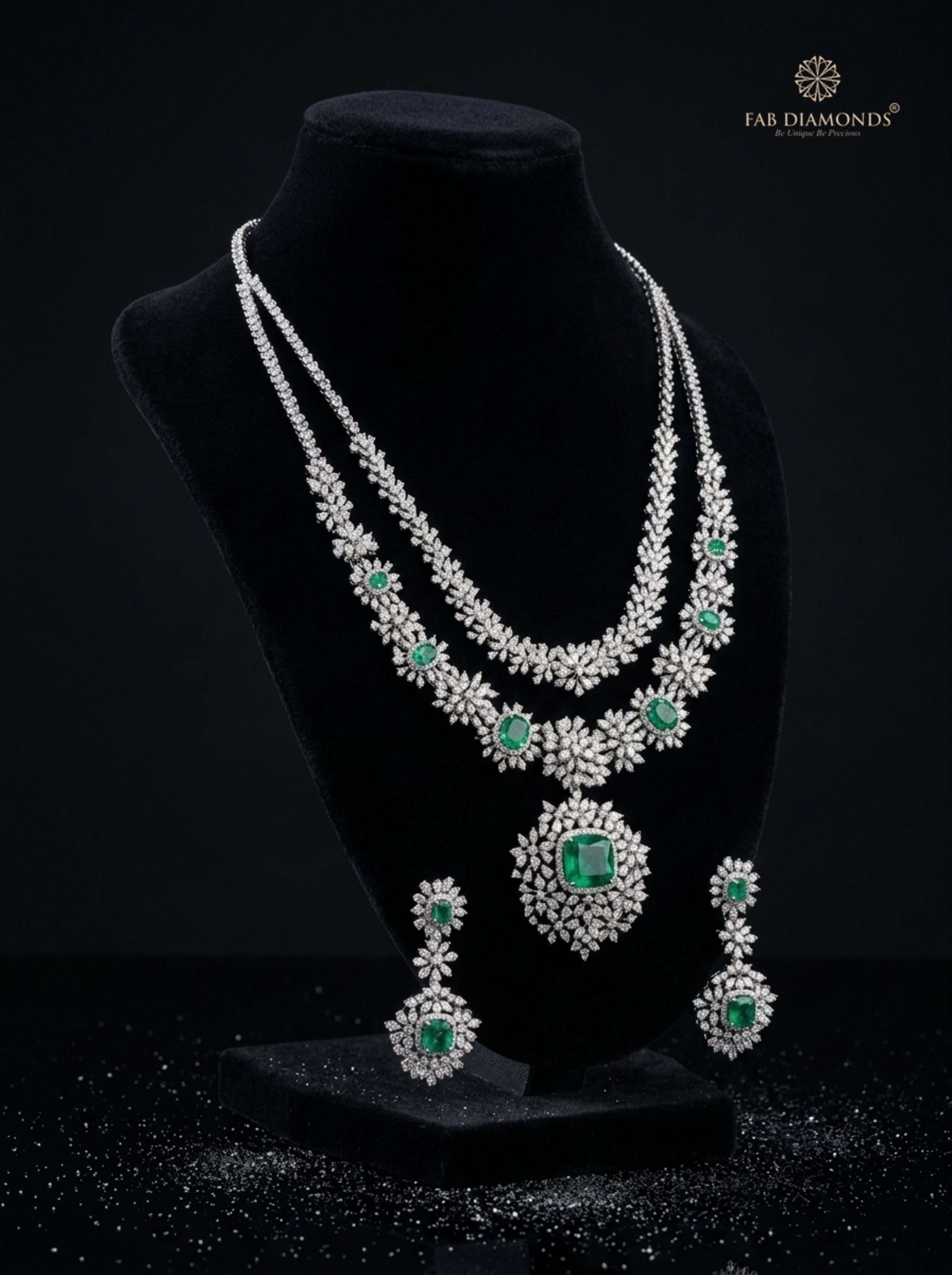 Radhika layered diamond riviere and emerald cushion medallion suite on elegant black velvet showcase bust with diamond reflections