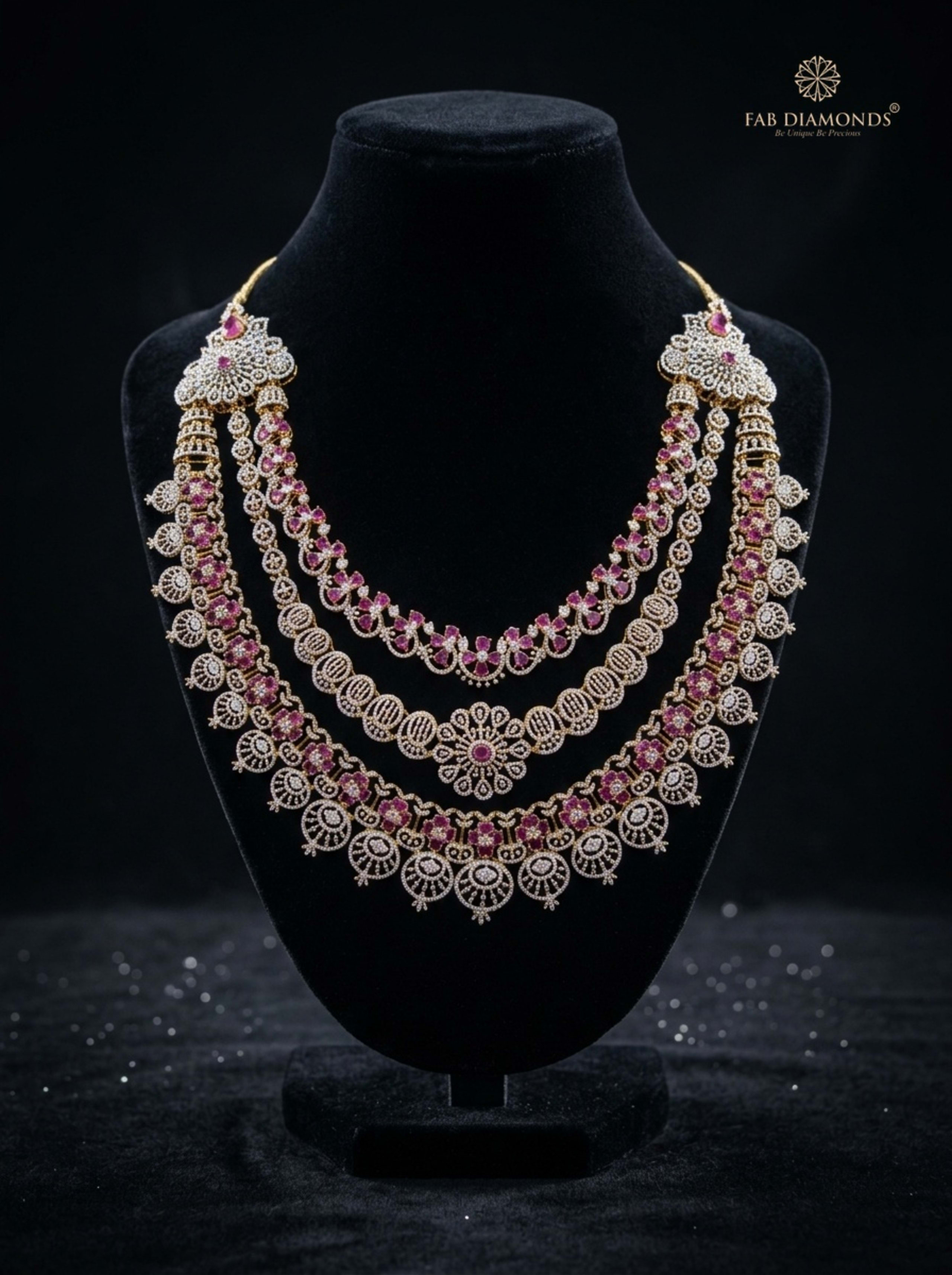 Vaishnavi three-tier tourmaline and diamond bridal rani haar flat-lay on ivory champagne silk with peacock feather and river stone