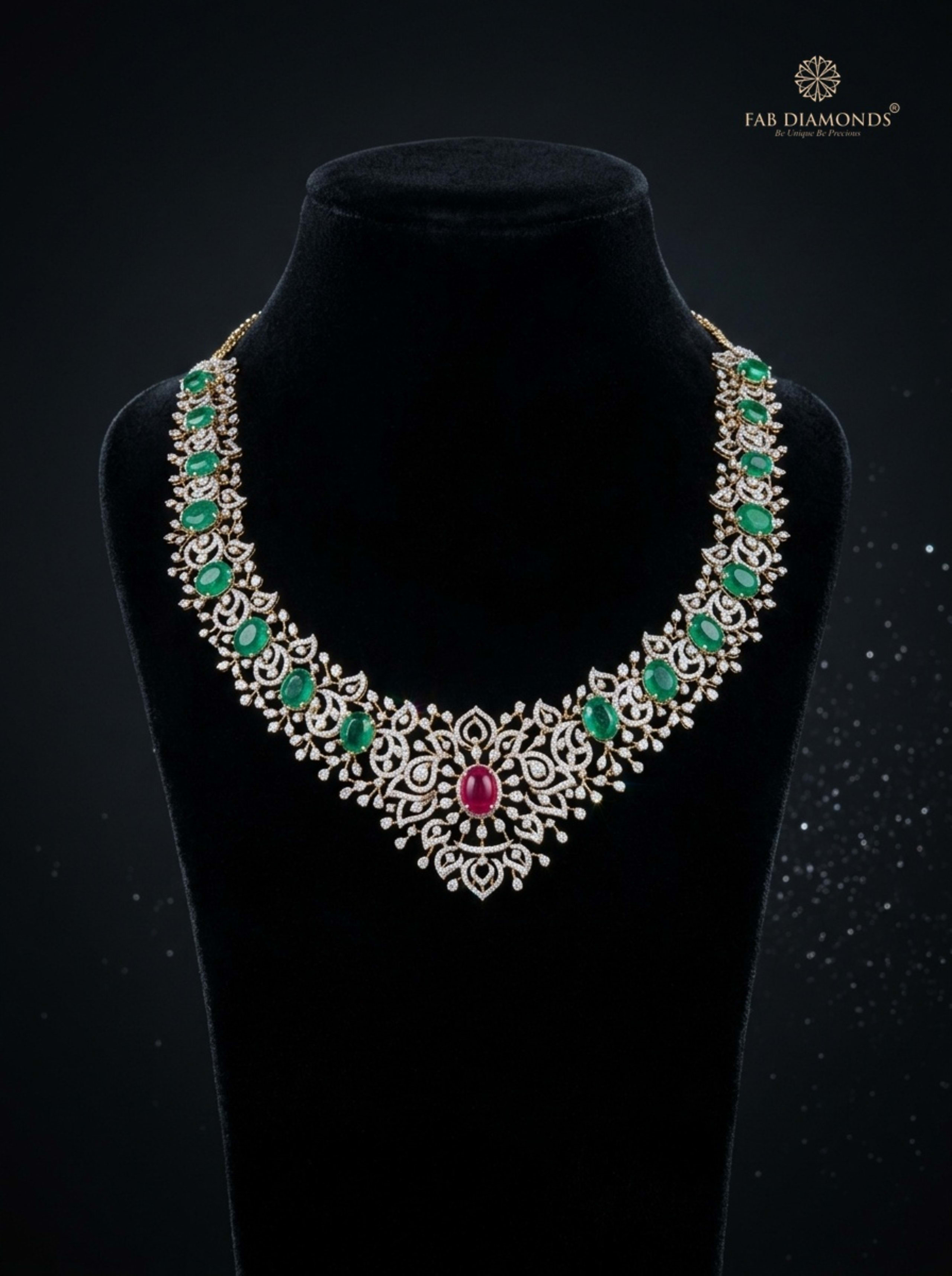 Malini emerald wreath necklace with ruby floral medallion on luxury velvet bust