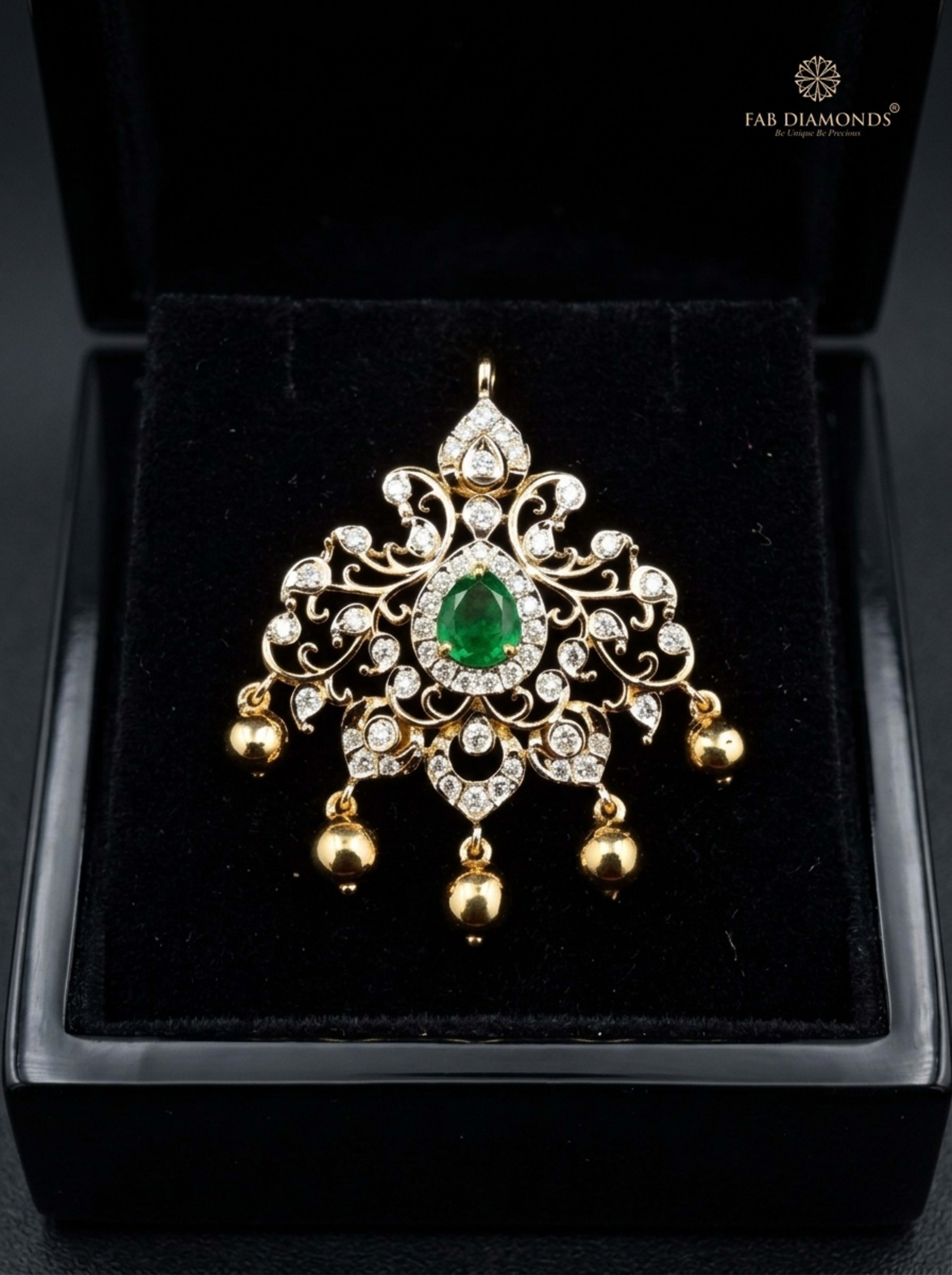 Tarini marquise emerald and ruby teardrop pendant resting on plush black velvet in glossy black display box