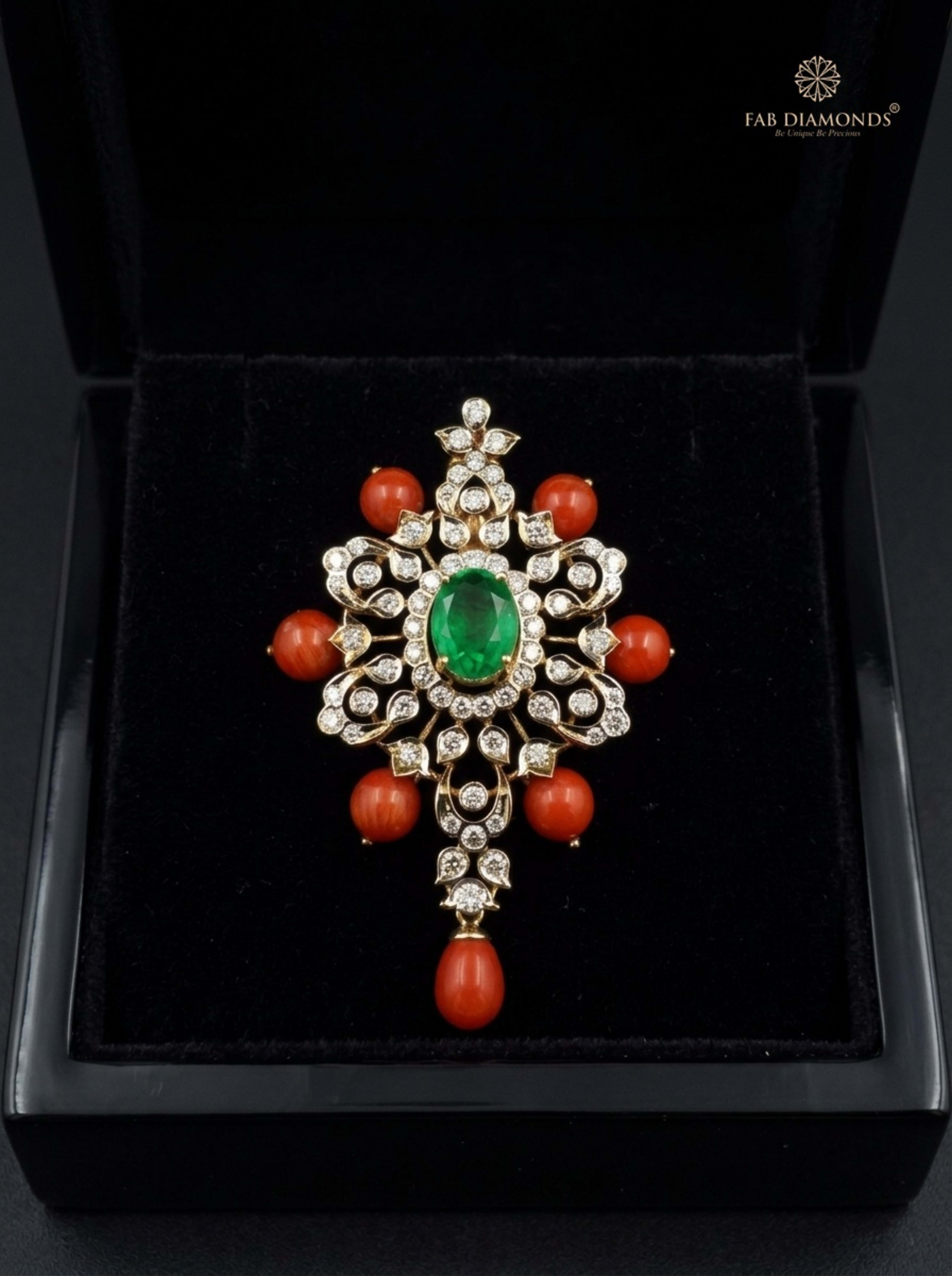 Navaratna carved coral and emerald talisman pendant resting on plush black velvet in glossy black display box