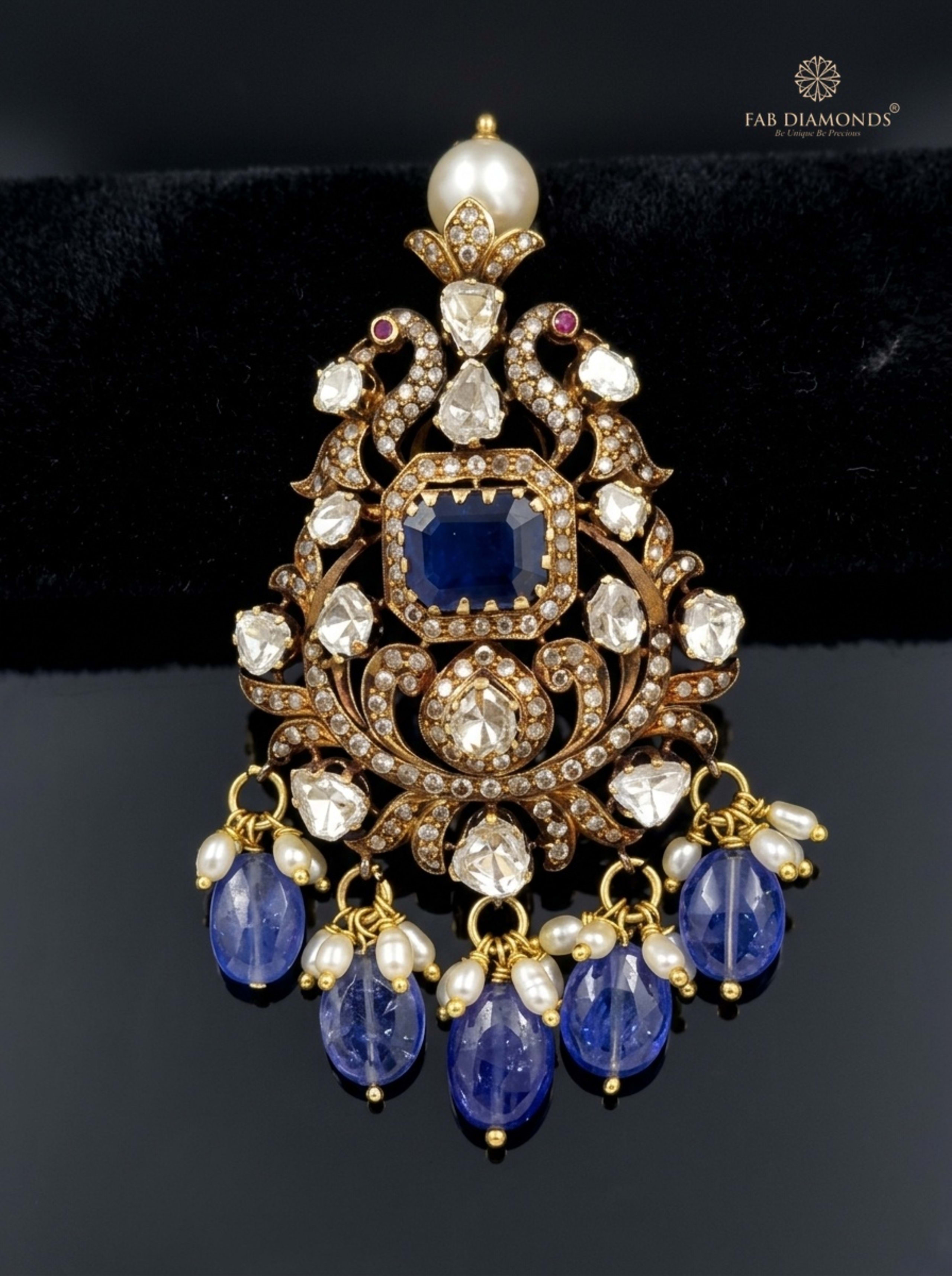 Neelam blue sapphire and rice pearl drop pendant resting on white scalloped linen dish