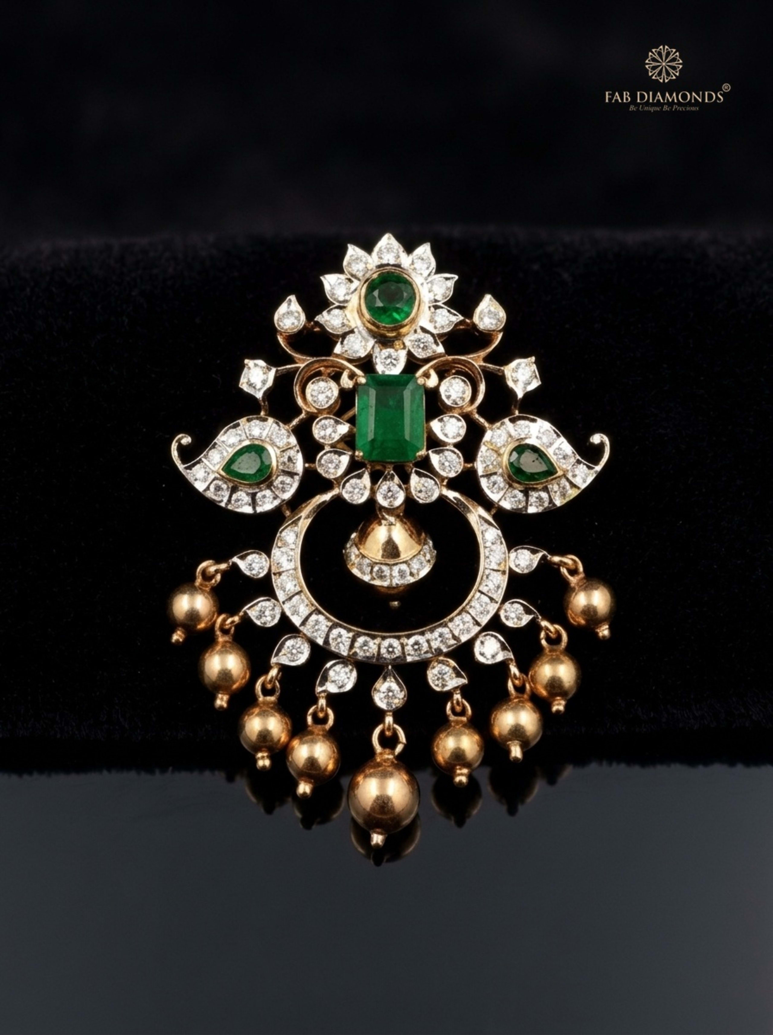 Chitra radiant emerald and diamond teardrop pendant displayed in antique gilded mirror setting