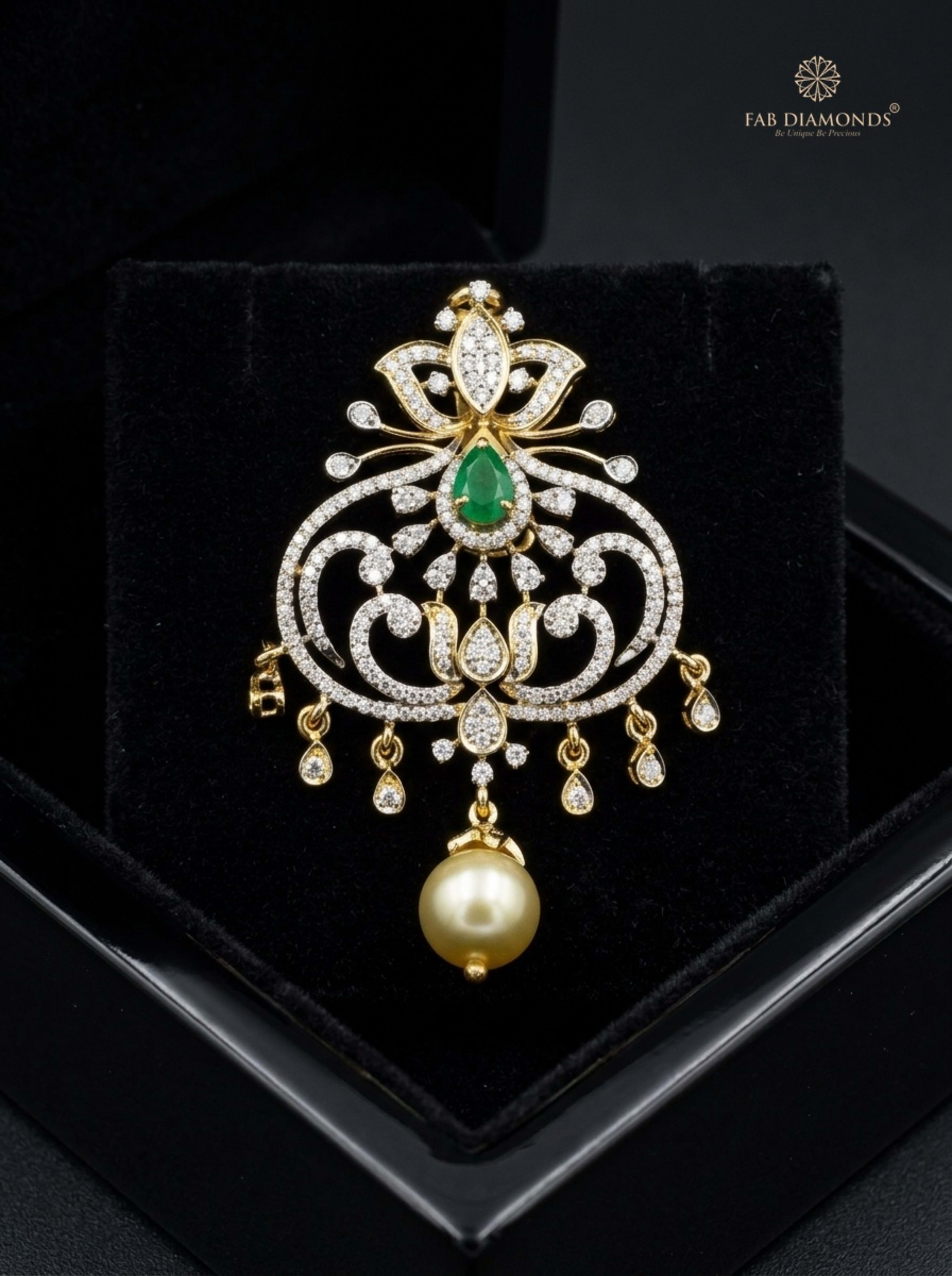 Deepa cluster emerald and South Sea pearl pendant resting on plush black velvet in glossy black display box