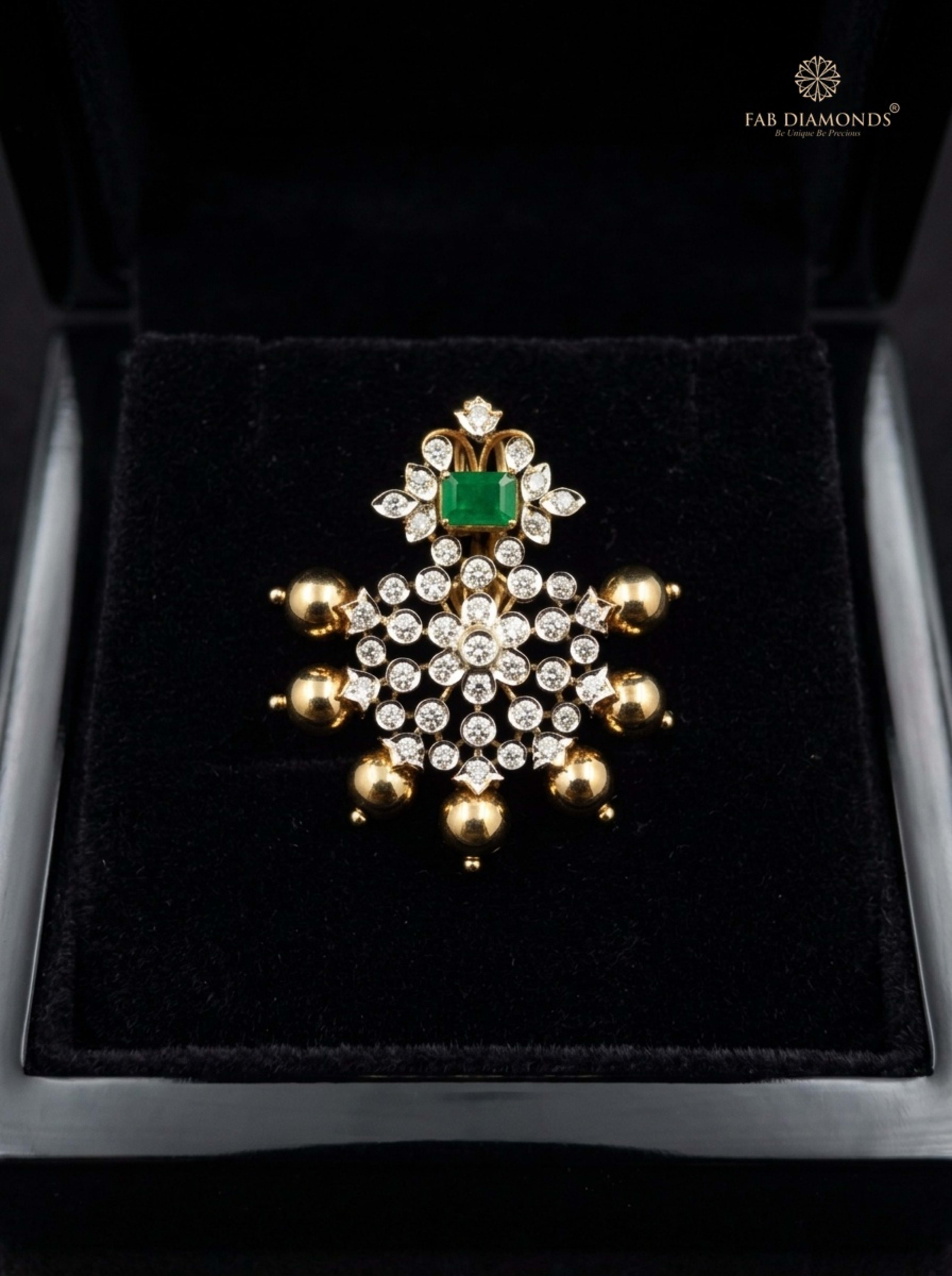 Shanta marquise emerald and diamond drop pendant resting on plush black velvet in glossy black display box