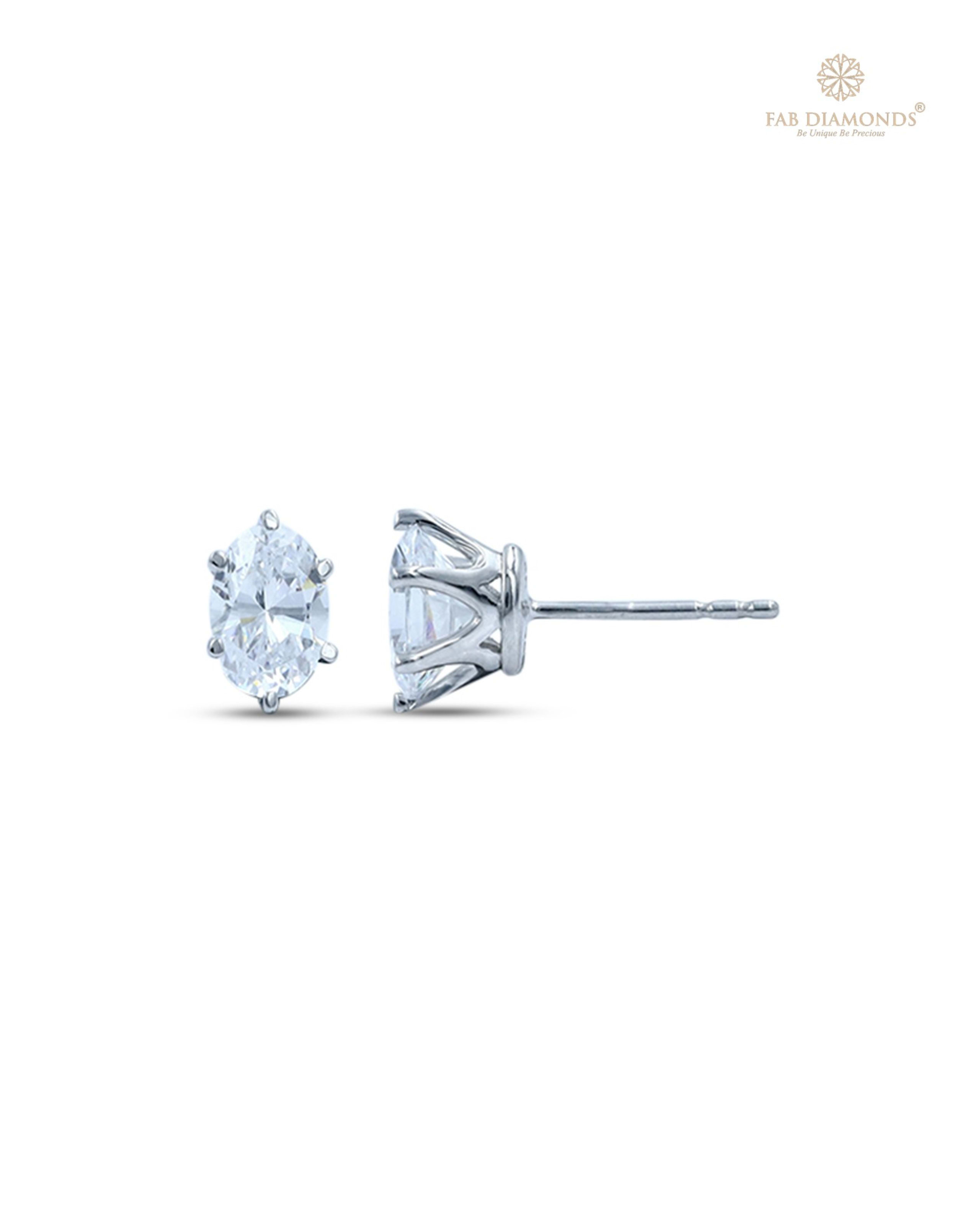 The EA07OV050 Oval-Cut Diamond Studs (1.00 Cts) on white atelier plate with FAB hallmark