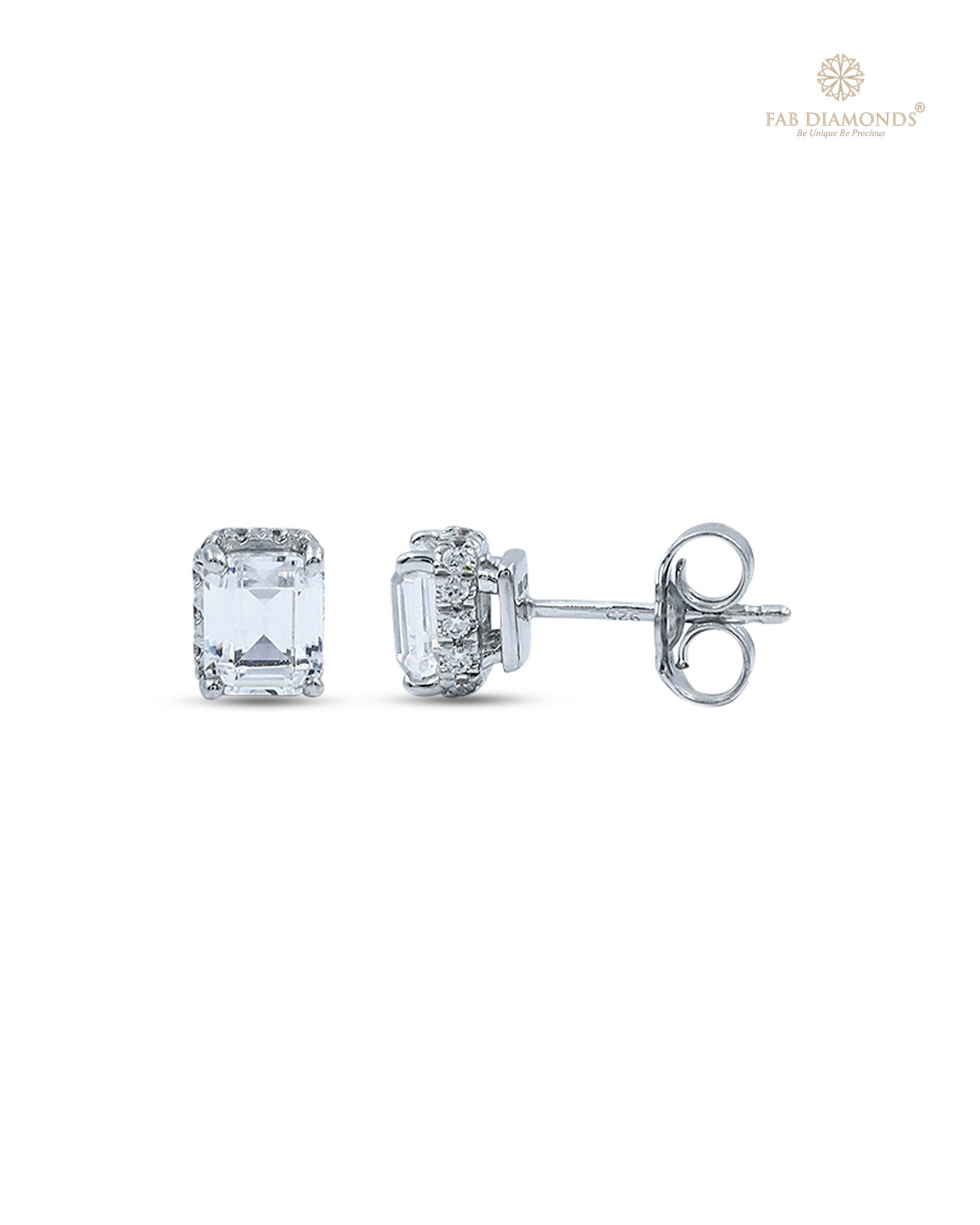 The EA21EM050 Emerald-Cut Diamond Studs (1.15 Cts) on white atelier plate with FAB hallmark