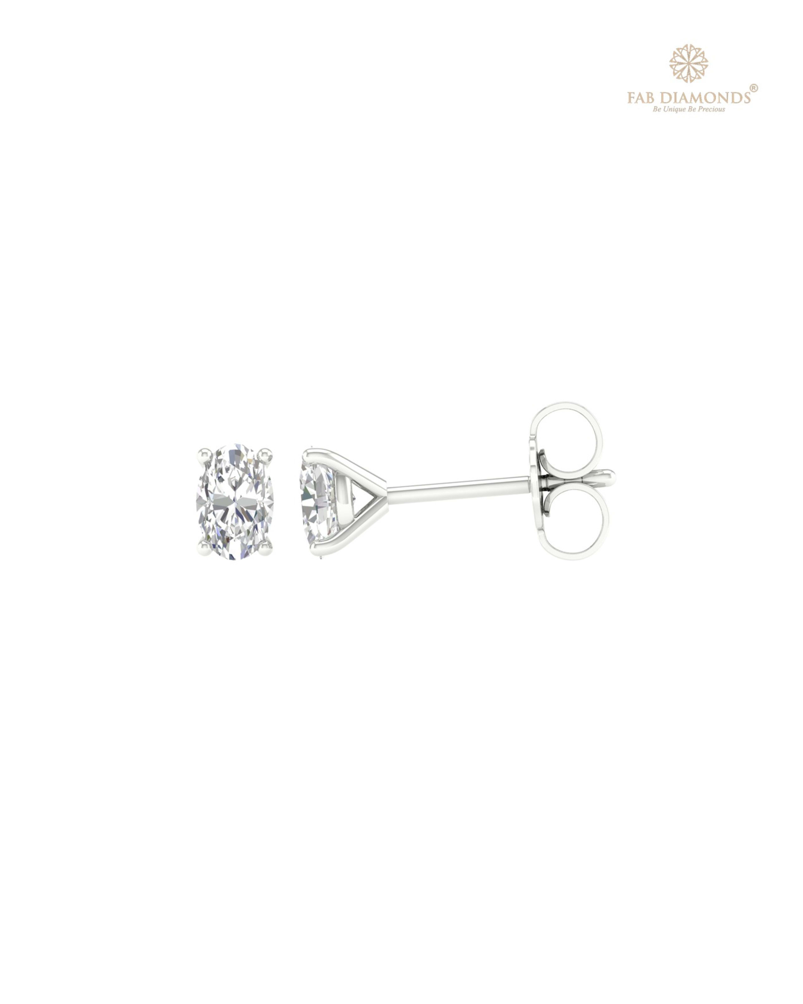 The ES01531 Classic Solitaire Diamond Studs (0.54 Cts) on white atelier plate with FAB hallmark