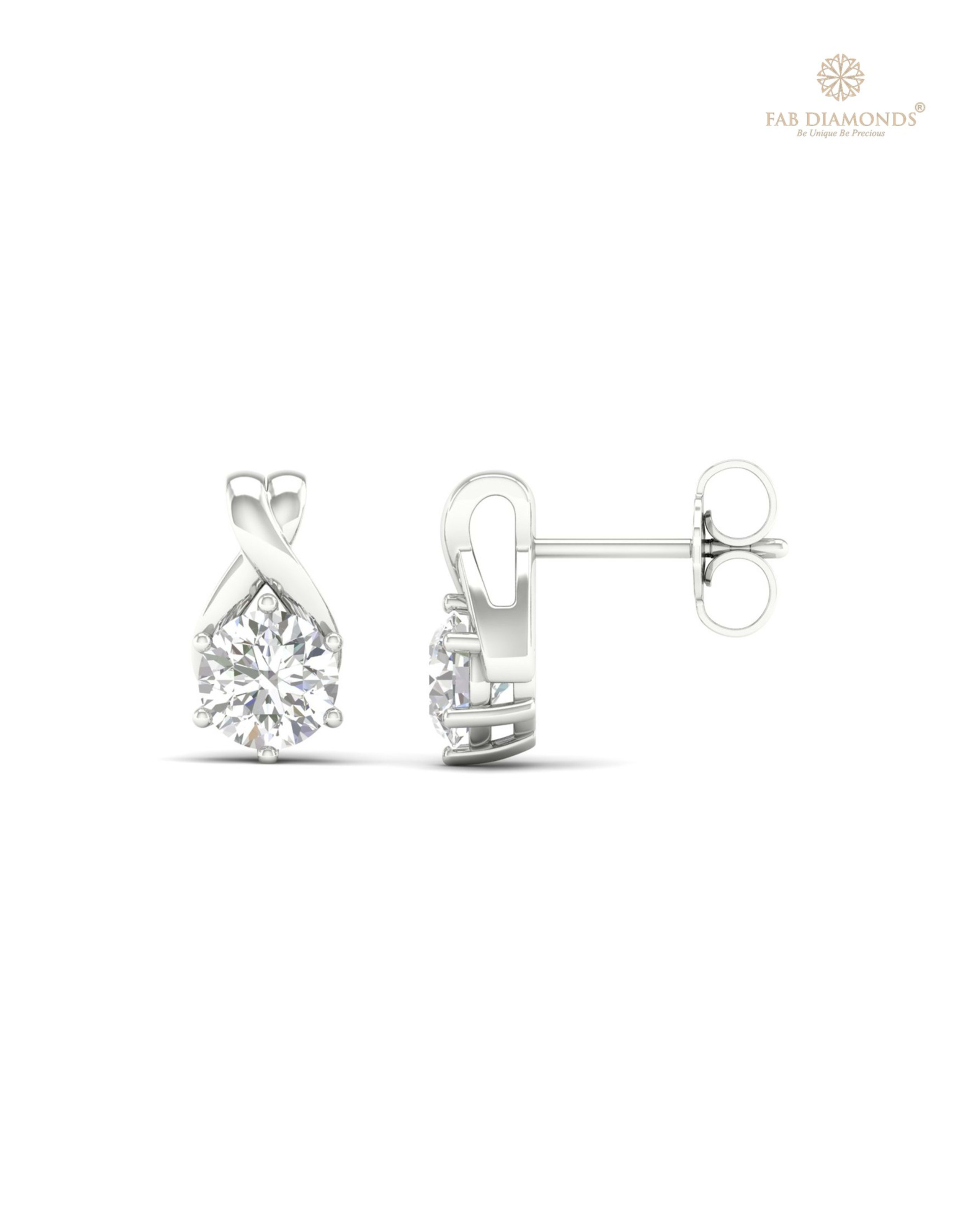 The ES10599 Classic Solitaire Diamond Studs (1.40 Cts) on white atelier plate with FAB hallmark