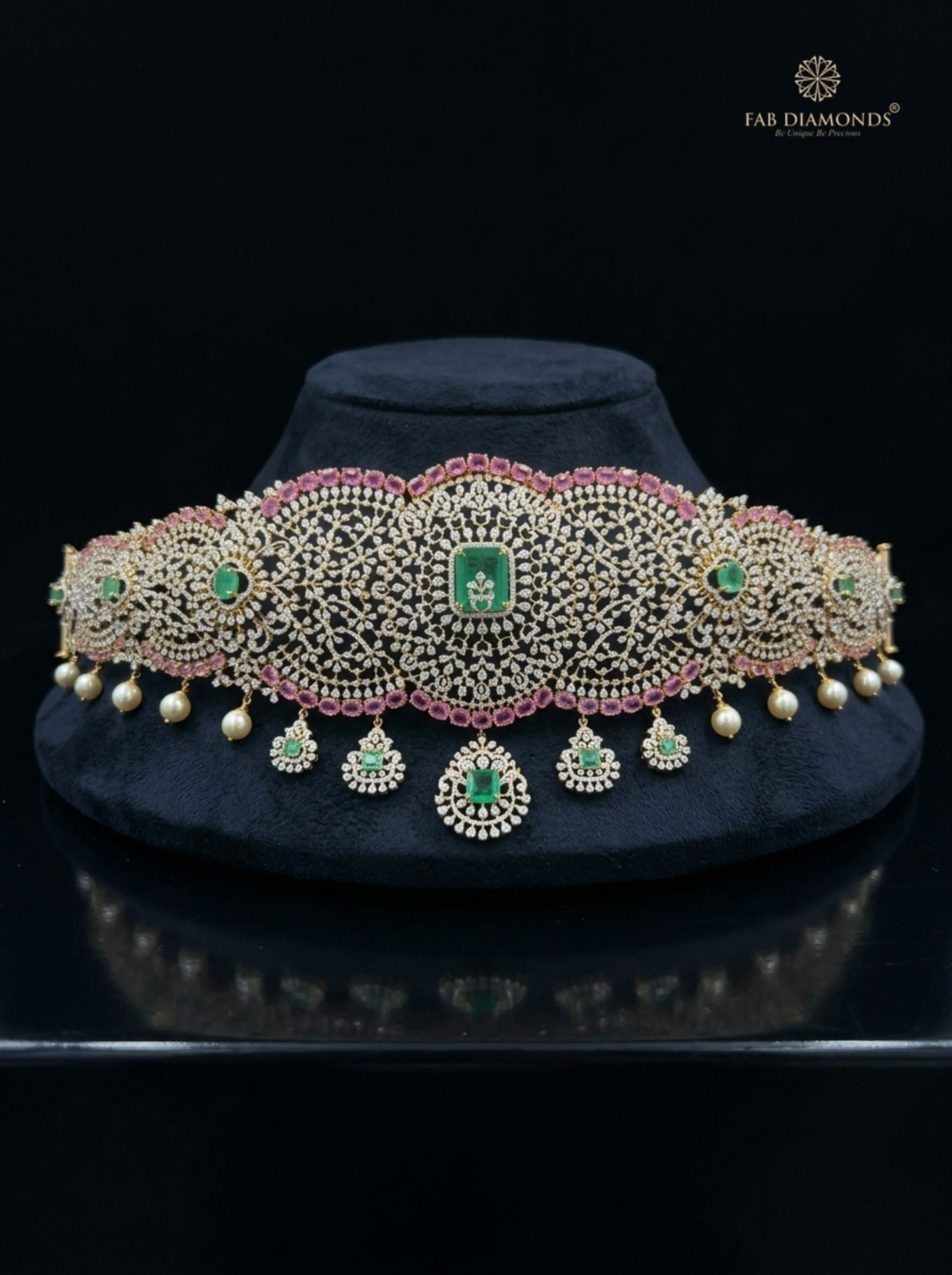 Meenakshi grand contour sapphire and emerald vaddanam on plum velvet plinth
