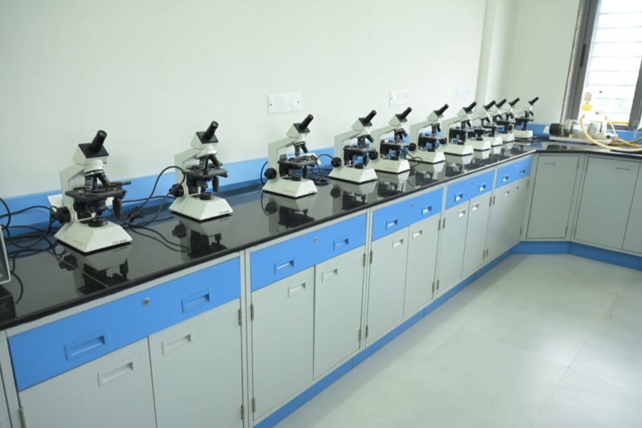 A row of microscopes set out along a laboratory bench