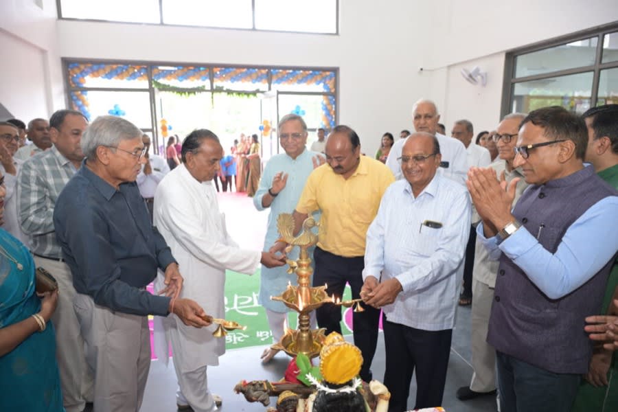 Guests lighting a ceremonial lamp at a campus event