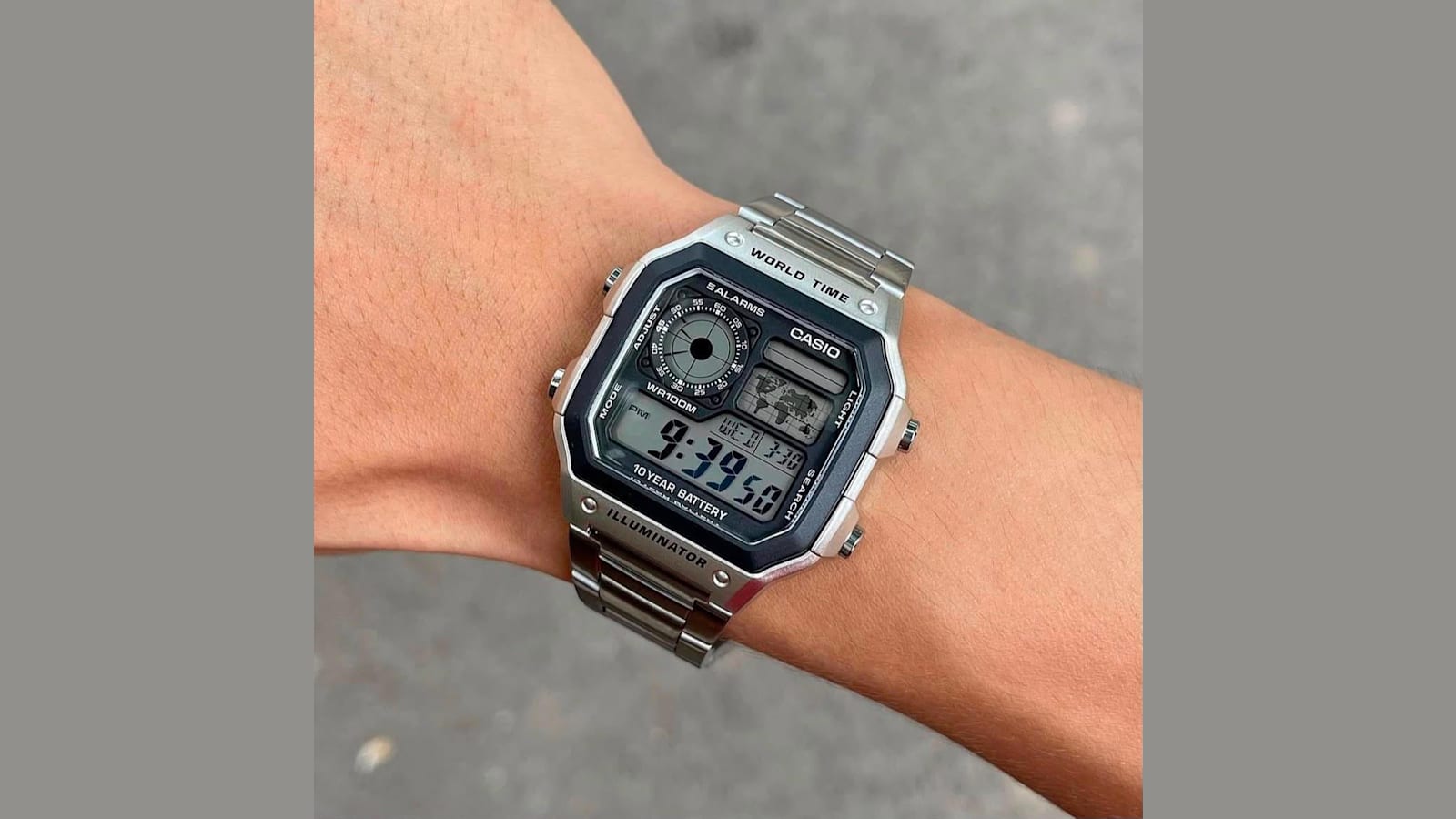 Casio World Time digital watch with a steel bracelet worn on a wrist
