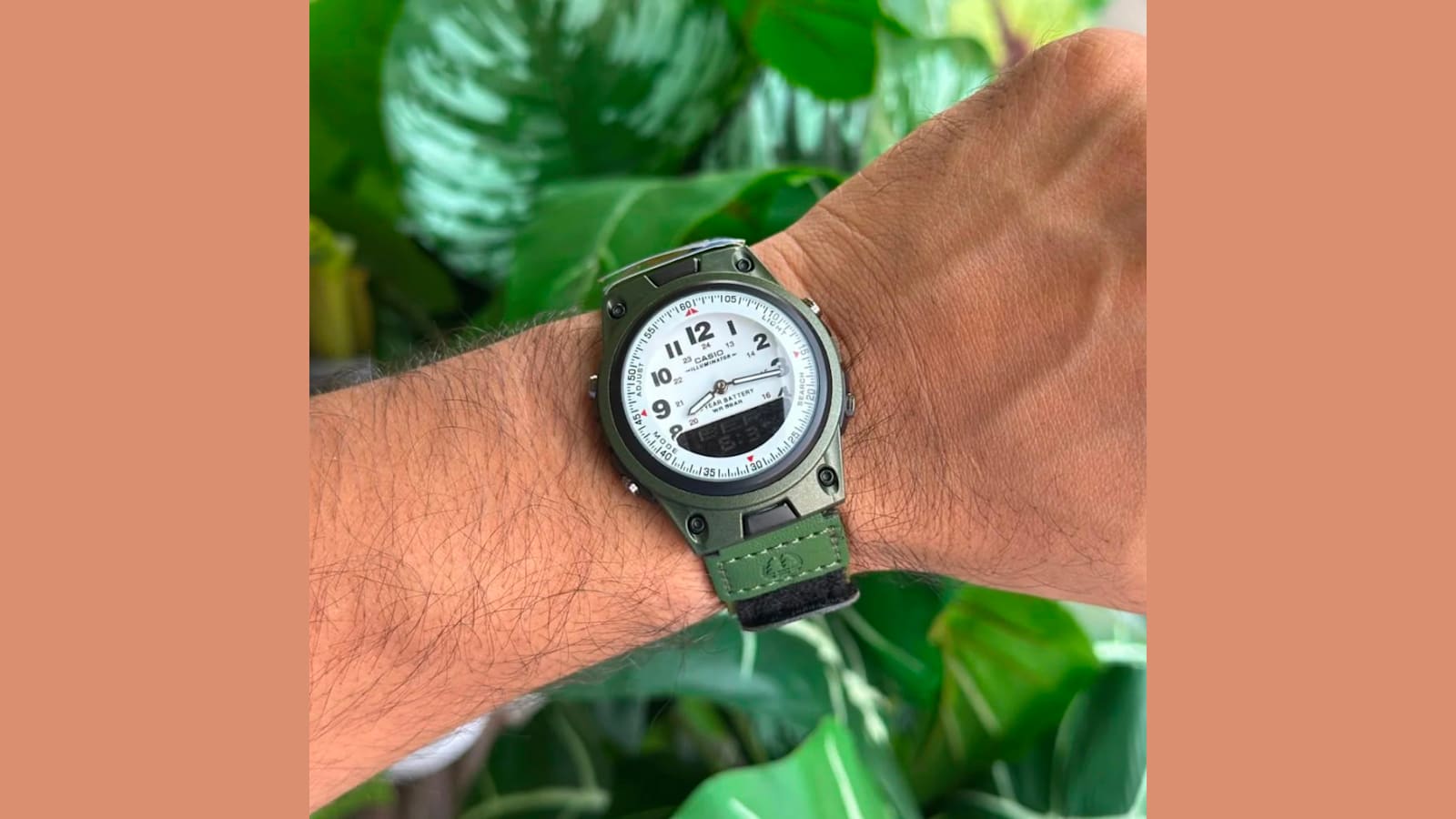 Casio Dualtime analog-digital watch with a green cloth strap worn on a wrist