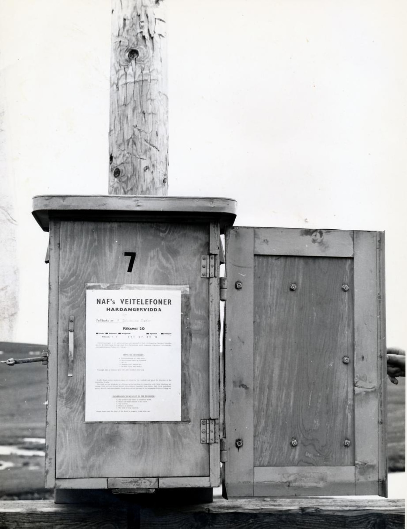 Et historisk bilde av en telefonboks fra NAF på Hardangervidda.