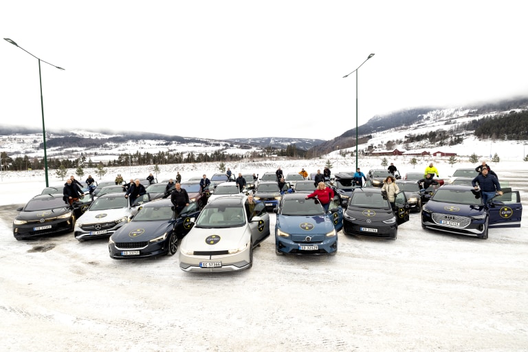 Elbiler og sjåfører på en parkeringsplass vinterstid