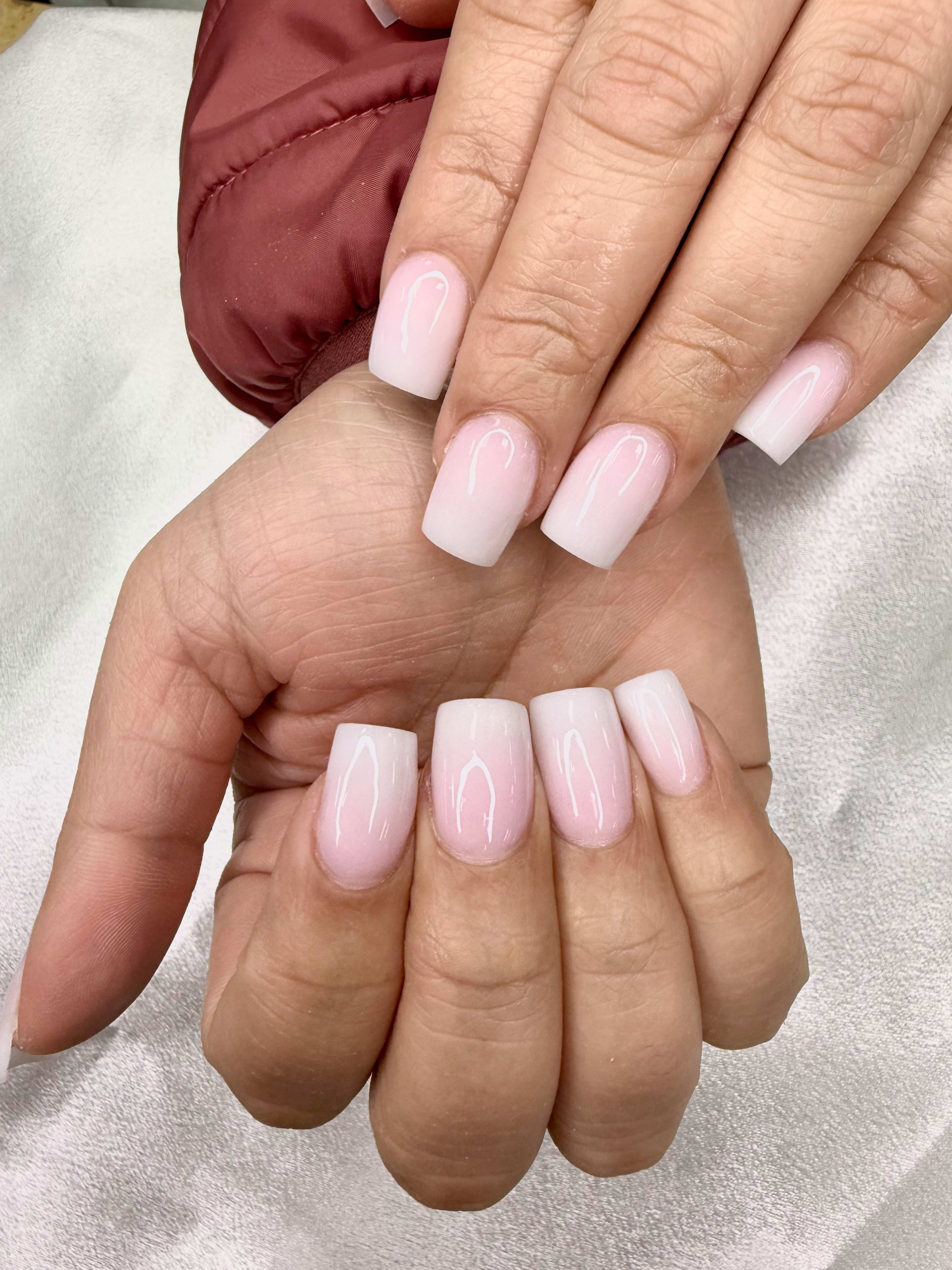 Soft pink ombre nails with a glossy finish.