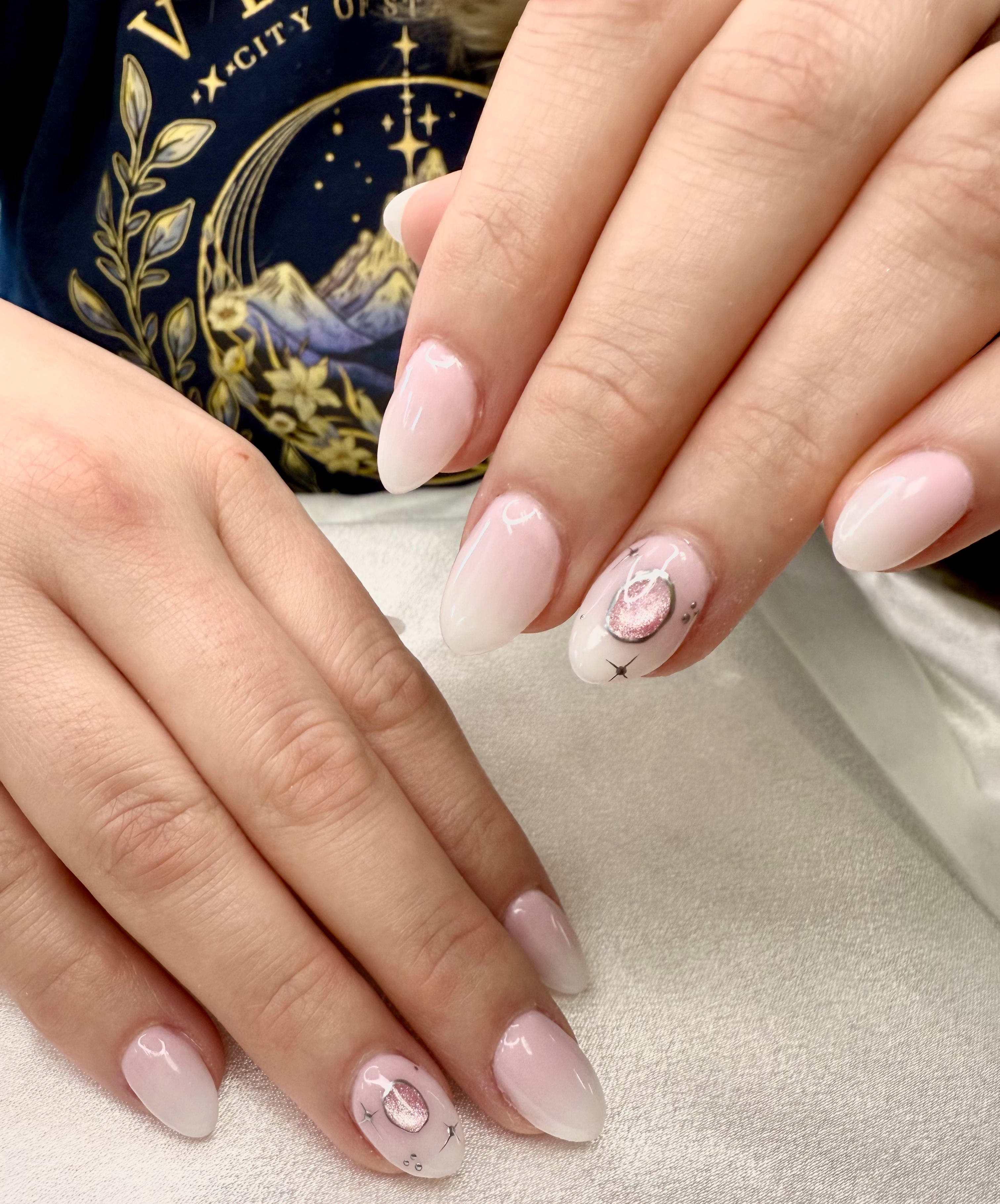 Light pink nails with delicate metallic accents.