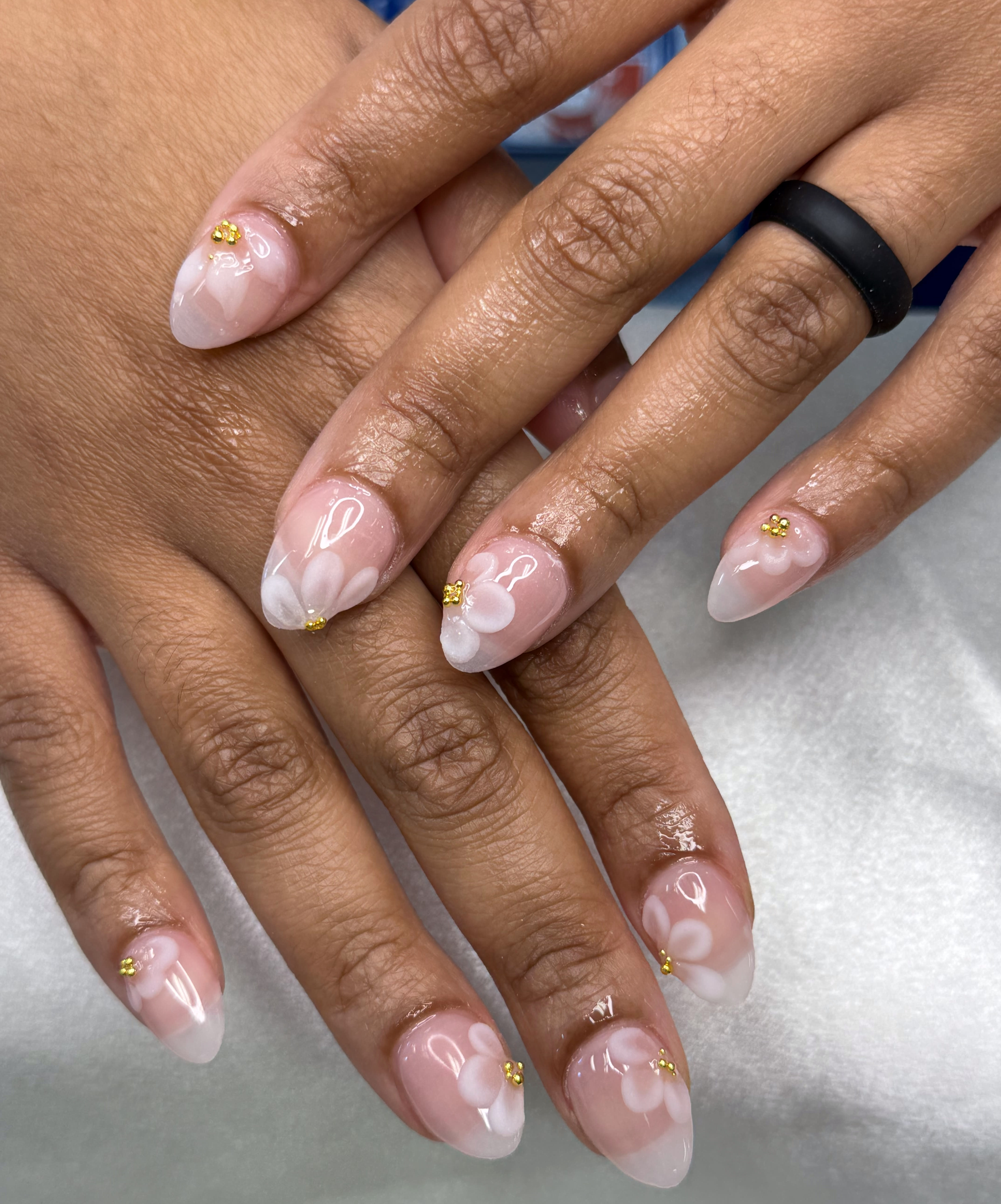 Clear nails with delicate white flowers and gold accents