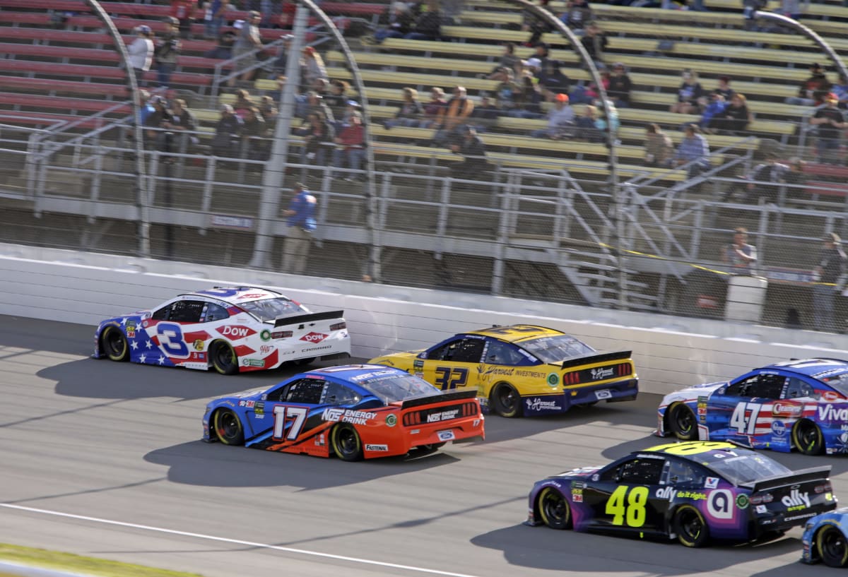 Austin Dillon successfully navigates his No. 3 Dow Salutes Veterans Chevrolet through a heap of cars to take stage two of the Firekeeper&apos;s Casino 400.