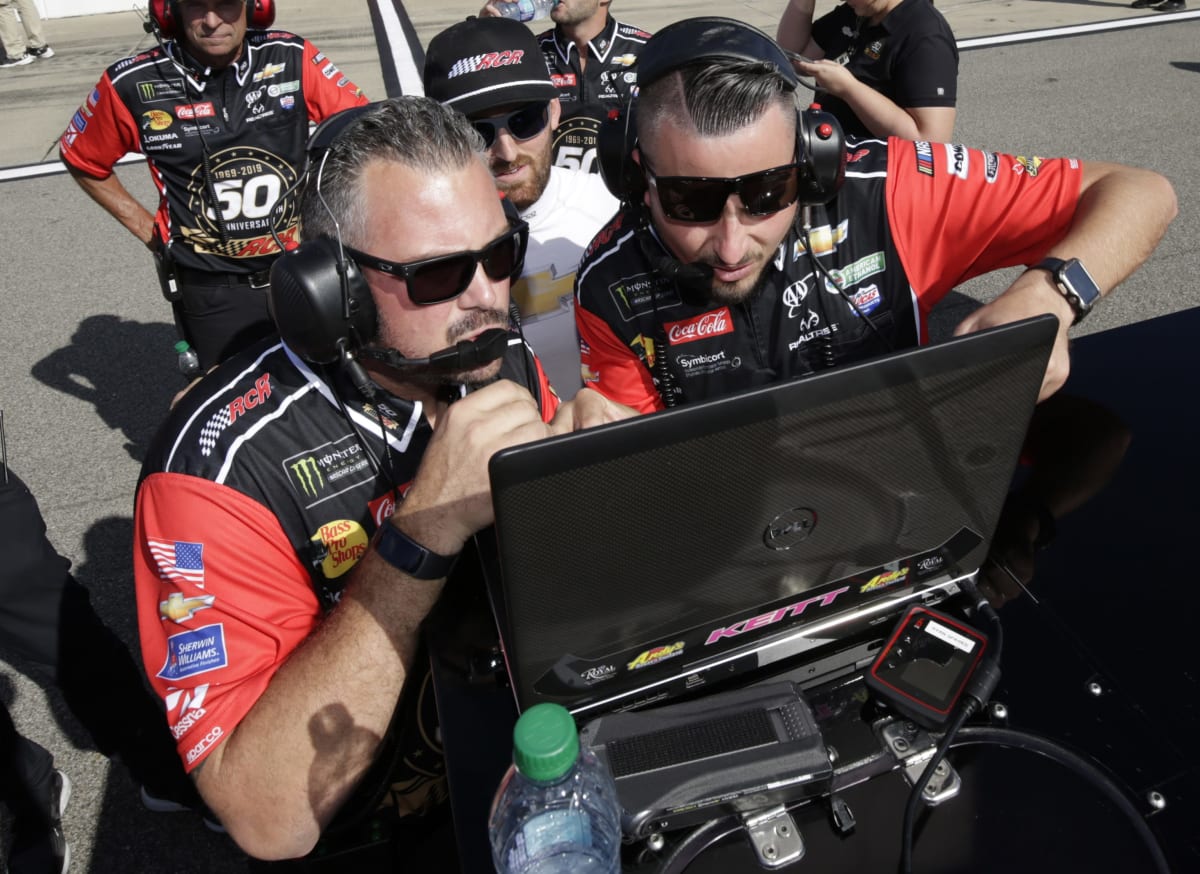 Crew chief Danny Stockman, race engineer Ryan Sparks and Austin Dillon look at the scoring monitor during qualifying at Michigan International Speedway. (HHP/Alan Marler)