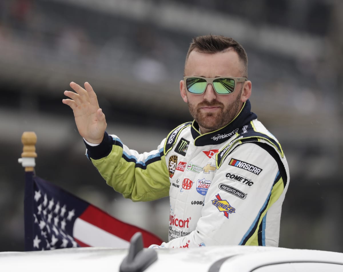 Austin Dillon rides in the back of a truck saluting the fans prior to the running of Sunday's Brickyard 400 at Indianapolis Motor Speedway. (HHP/Harold Hinson)