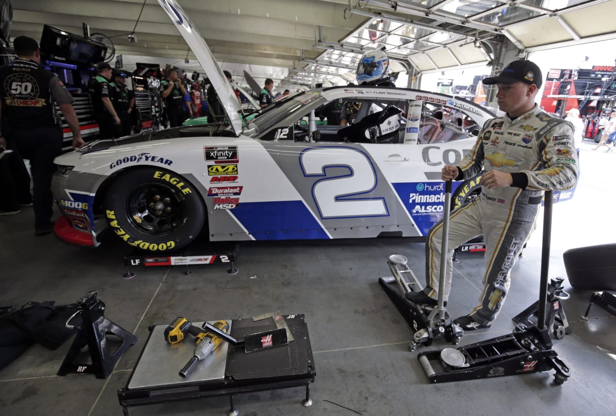 Tyler Reddick stands in the garage as the team makes changes to the No. 2 Emerson Chevrolet during Friday's practice at the Roval.