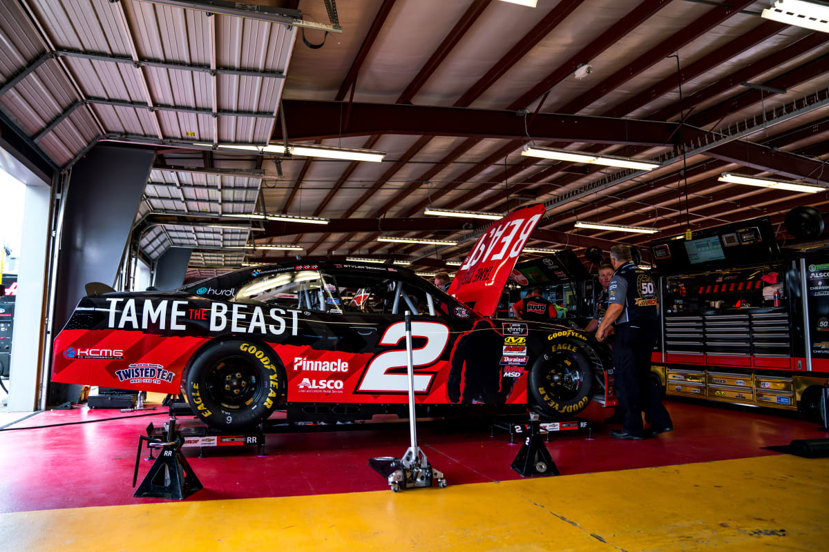 The No. 2 Tame the Beast crew prepares their Chevrolet Camaro for opening practice at Iowa Speedway.