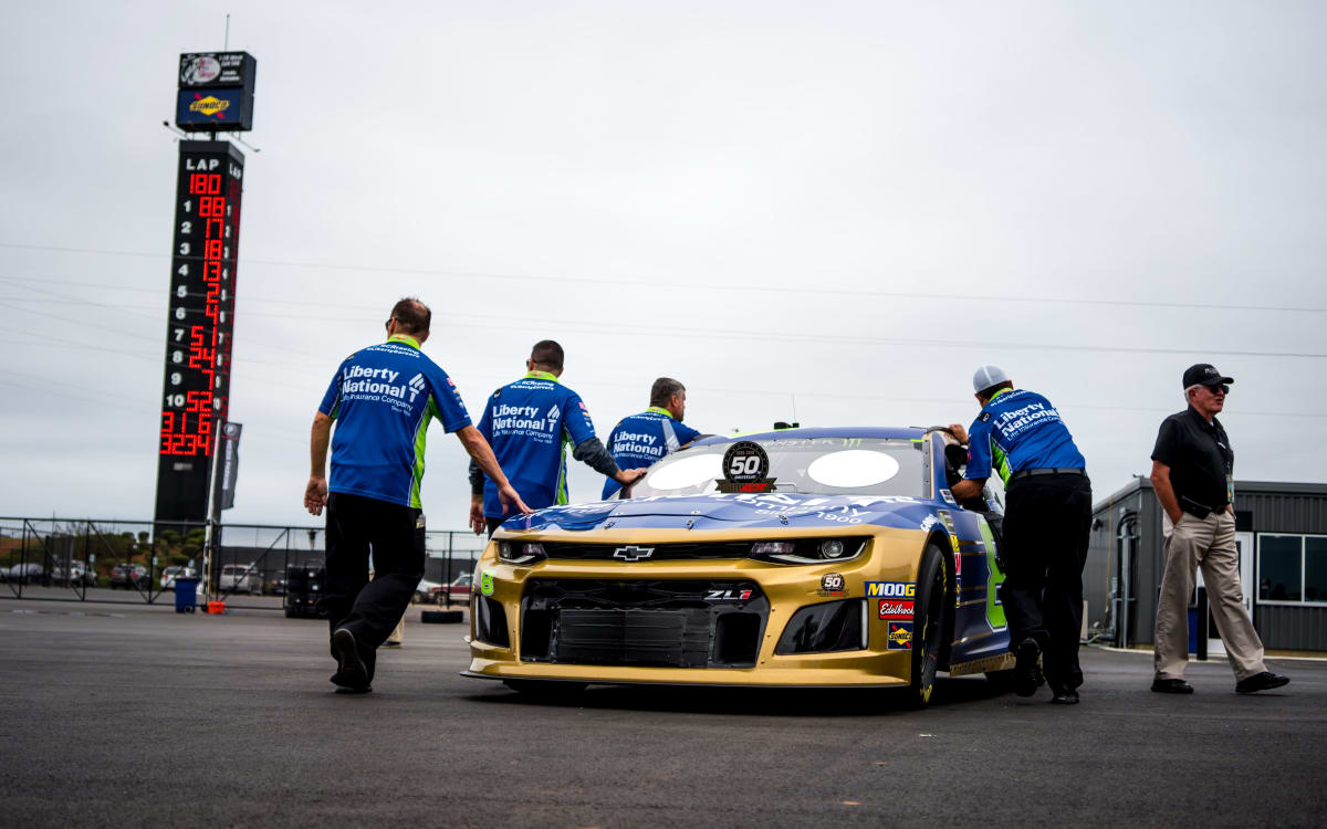 The No. 8 road crew pushes Daniel Hemric's Liberty National/RCR 50th Chevrolet through the Talladega Superspeedway garage prior to opening practice on Friday.