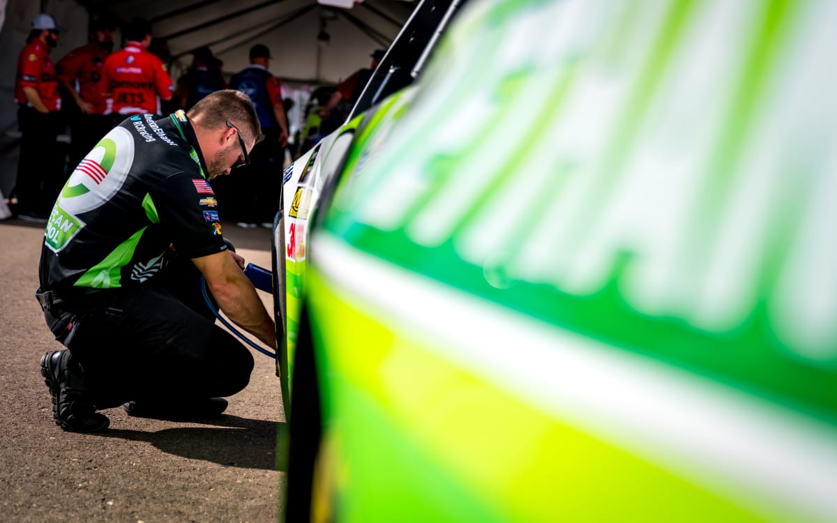 Car chief Ryan Chism checks the tire pressure on Austin Dillon's No. 3 American Ethanol Chevrolet before going into NASCAR's optical scanning system on Friday.