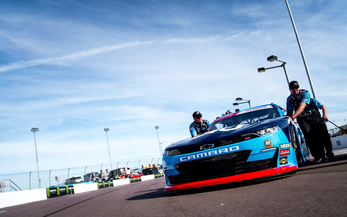 The No. 2 team pushes Tyler Reddick's Chevrolet into the garage stall ahead of opening NASCAR Xfinity Series practice.