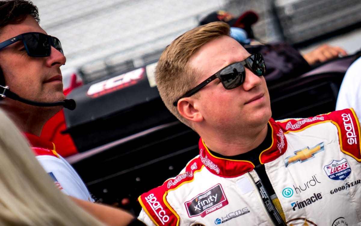 Tyler Reddick and crew chief Randall Burnett look down pit road while waiting to go out for qualifying at Indianapolis Motor Speedway.