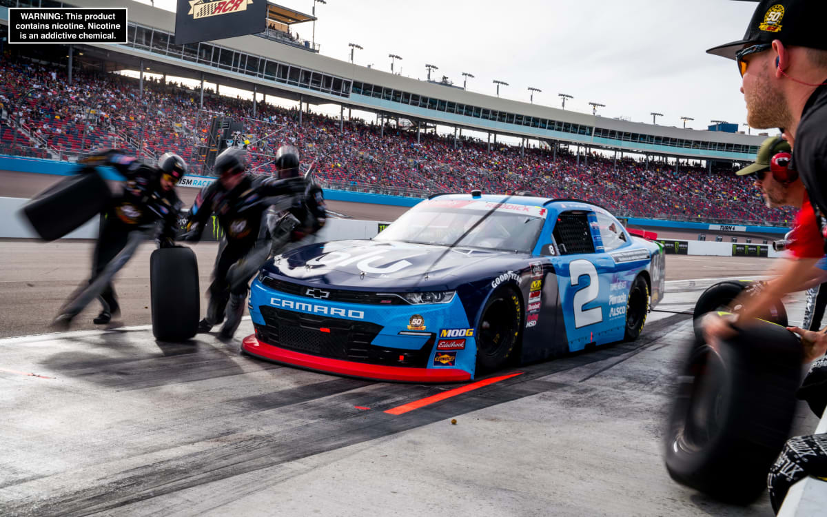 The No. 2 crew goes to work around to the left side of Tyler Reddick's Chevrolet during a stage break in Saturday's Xfinity Series race at ISM Raceway.
