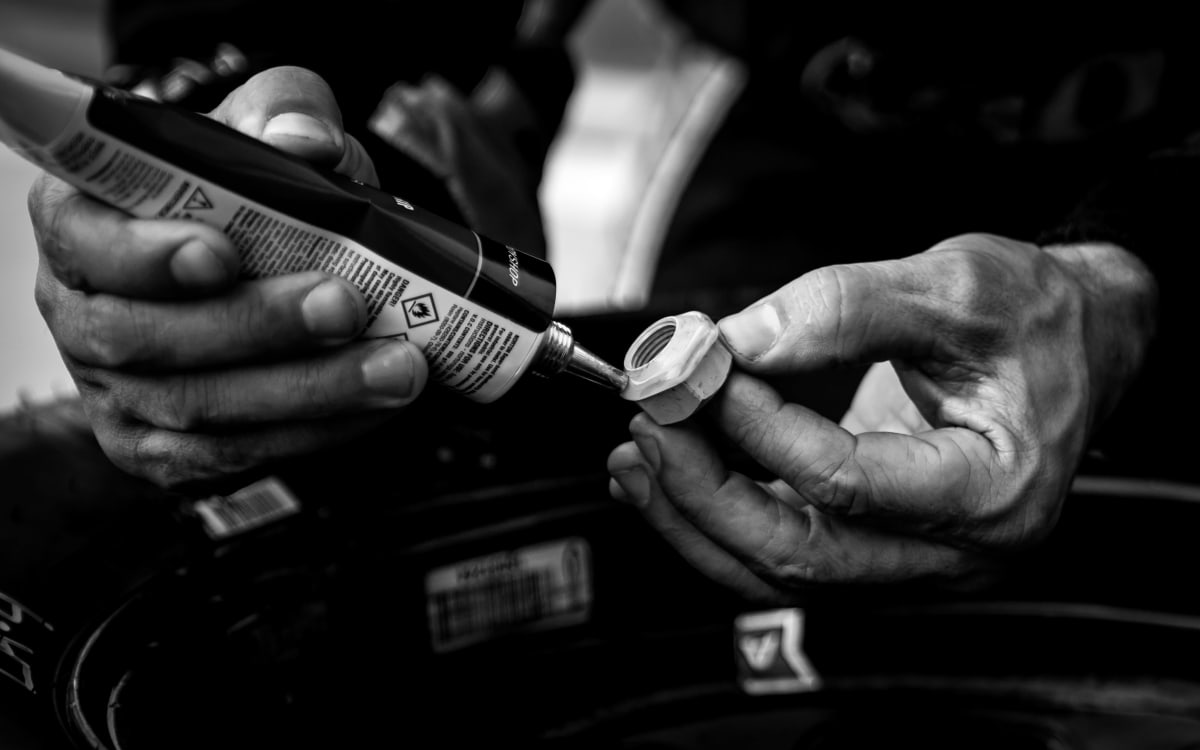 The No. 2 team glues up lug nuts after a pit stop during the stage break of Saturday's NASCAR Xfinity Series race at ISM Raceway.