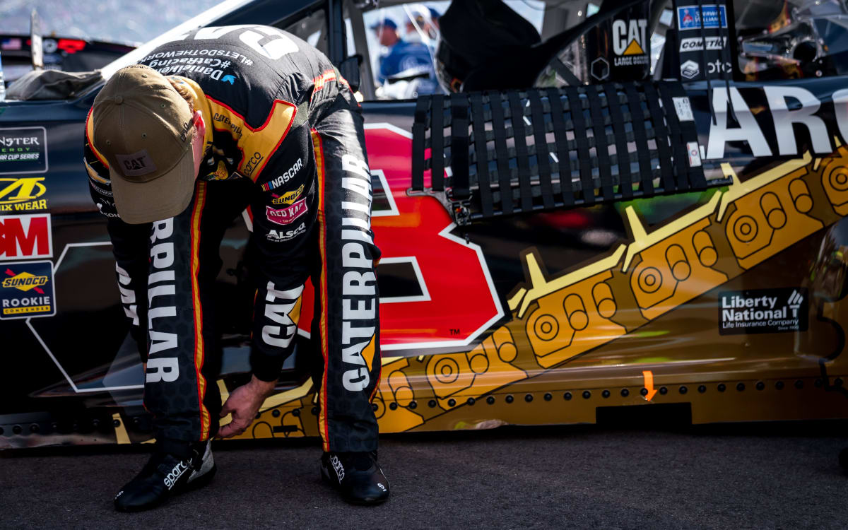 Daniel Hemric puts on his heat shields prior to climbing in the No. 8 Cat Large Dozers Chevrolet for Sunday's race at ISM Raceway.