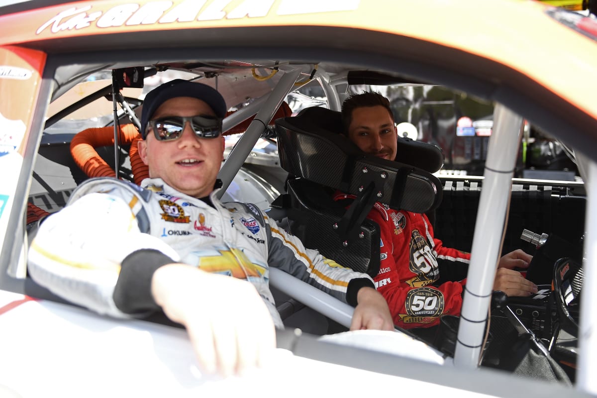 Tyler Reddick sits in the passenger side of Kaz Grala's No. 21 Hot Scream Chevrolet prior to practice at Road America.