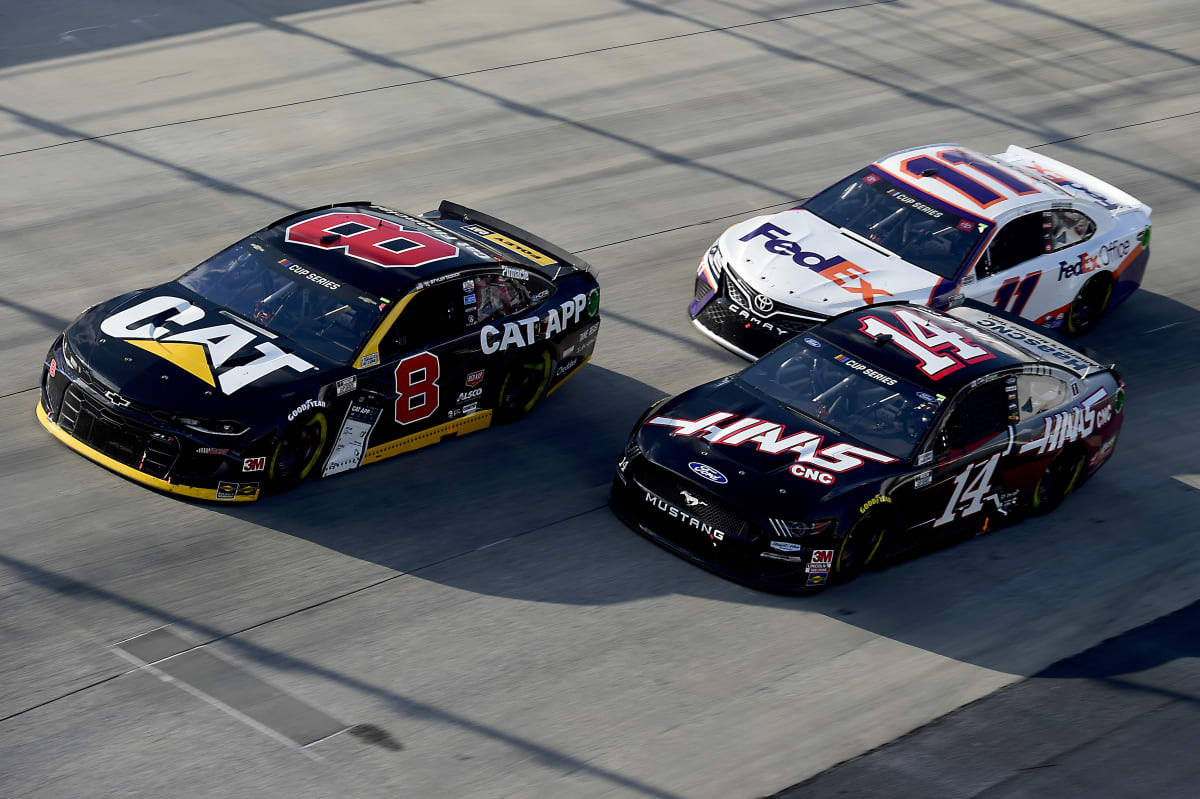 DOVER, DELAWARE - AUGUST 23: Tyler Reddick, driver of the #8 Cat App Chevrolet, Clint Bowyer, driver of the #14 Haas Automation Ford, and Denny Hamlin, driver of the #11 FedEx Office Toyota, race during the NASCAR Cup Series Drydene 311 at Dover International Speedway on August 23, 2020 in Dover, Delaware. (Photo by Jared C. Tilton/Getty Images) | Getty Images