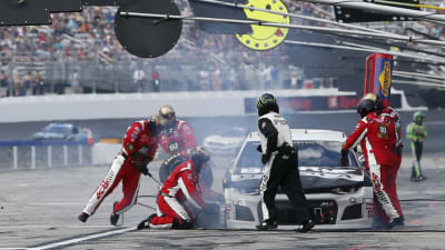 Austin Dillon coming in hot to pit road to exchange his old tires for new ones