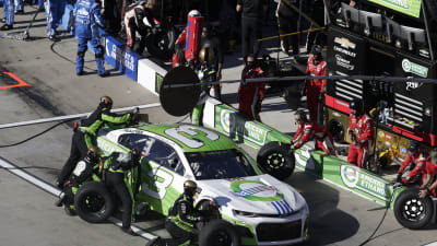 The No. 3 American Ethanol pit crew get to work during a mid-race stop.