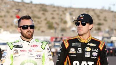 Teammates Austin Dillon and Daniel Hemric walk through the garage area to their cars for opening practice at ISM Raceway.