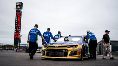 The No. 8 road crew pushes Daniel Hemric's Liberty National/RCR 50th Chevrolet through the Talladega Superspeedway garage prior to opening practice on Friday.