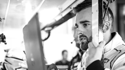 Austin Dillon examines the timing, scoring and data between runs in final practice at ISM Raceway.