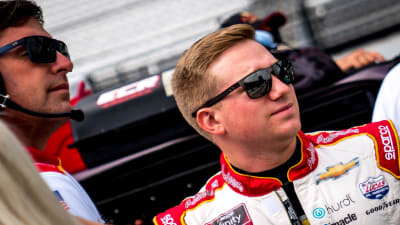 Tyler Reddick and crew chief Randall Burnett look down pit road while waiting to go out for qualifying at Indianapolis Motor Speedway.