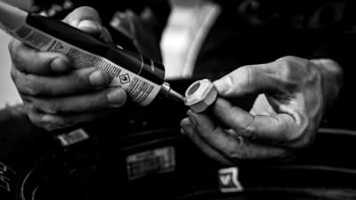 The No. 2 team glues up lug nuts after a pit stop during the stage break of Saturday's NASCAR Xfinity Series race at ISM Raceway.