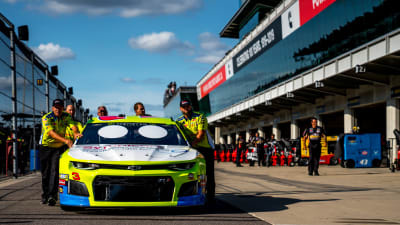 The No. 3 team push Austin Dillon's Chevrolet Camaro ZL1 through the Indianapolis Motor Speedway garage as they roll through the NASCAR technical inspection process.